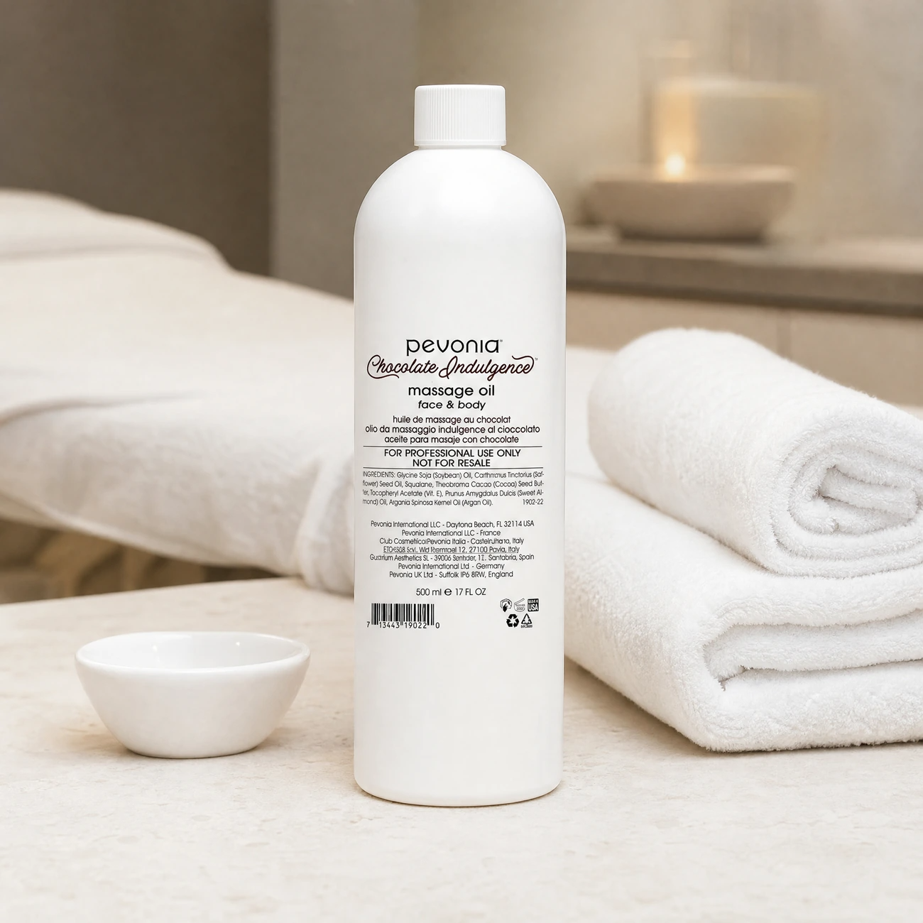 Pevonia Chocolate Indulgence Massage Oil Face & Body 500ml professional white bottle styled in a serene clinical spa treatment room for Beauty Collective Pro.
