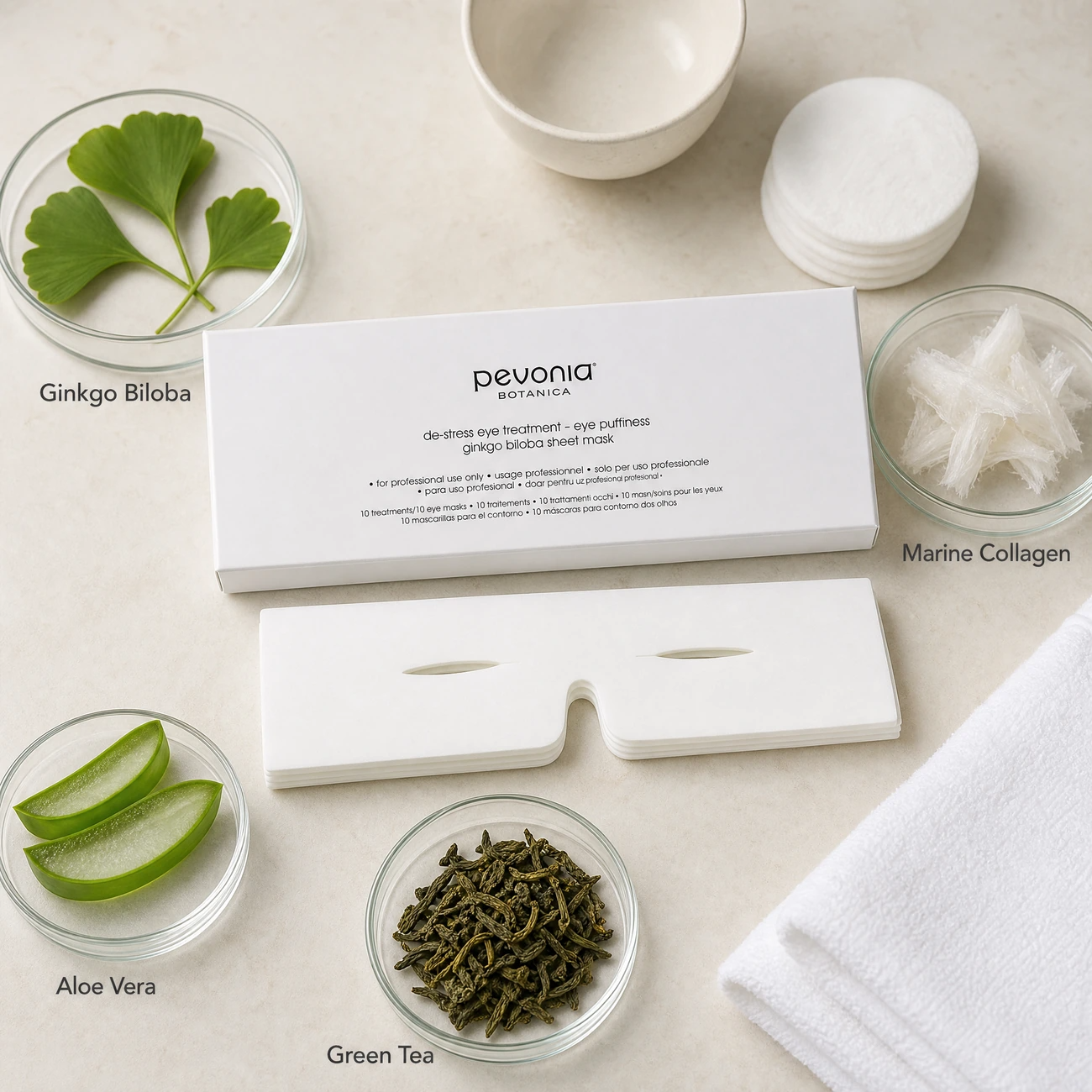Pevonia Botanica De-Stress Eye Puffiness Ginkgo ingredients flatlay with Ginkgo Biloba leaves, marine collagen, aloe vera, and green tea in clean glass petri dishes for professional B2B education.