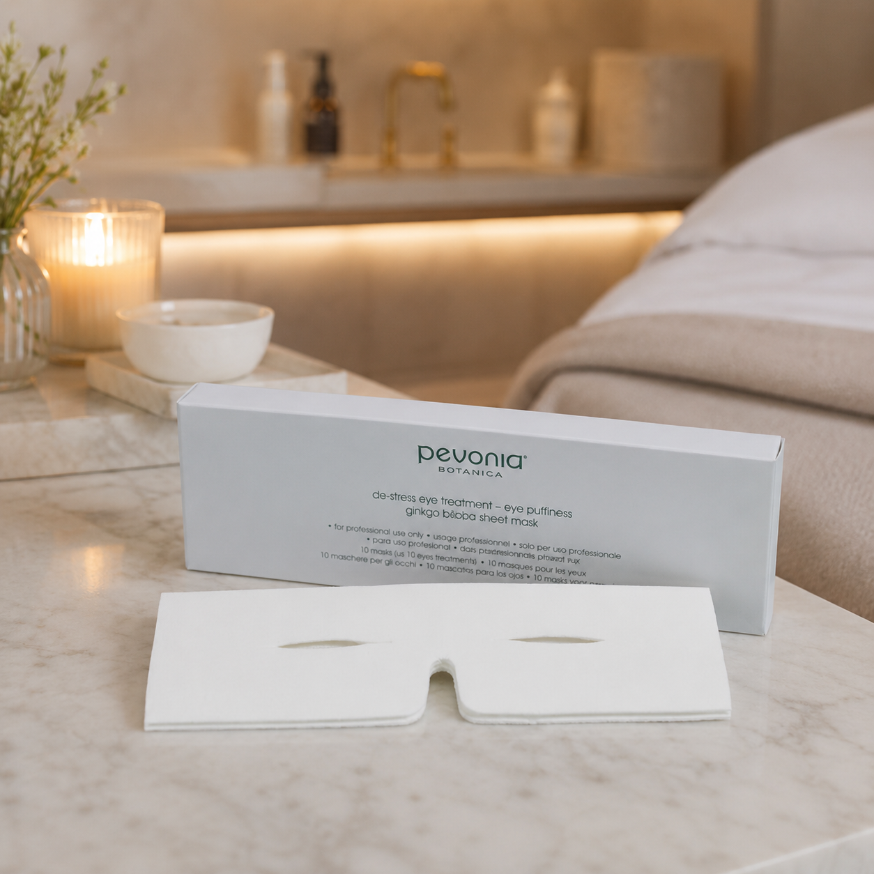 Pevonia De-Stress Eye Puffiness Ginko 10 pack displayed in an upmarket day spa facial treatment room with eye sheet mask and unbranded treatment accessories.