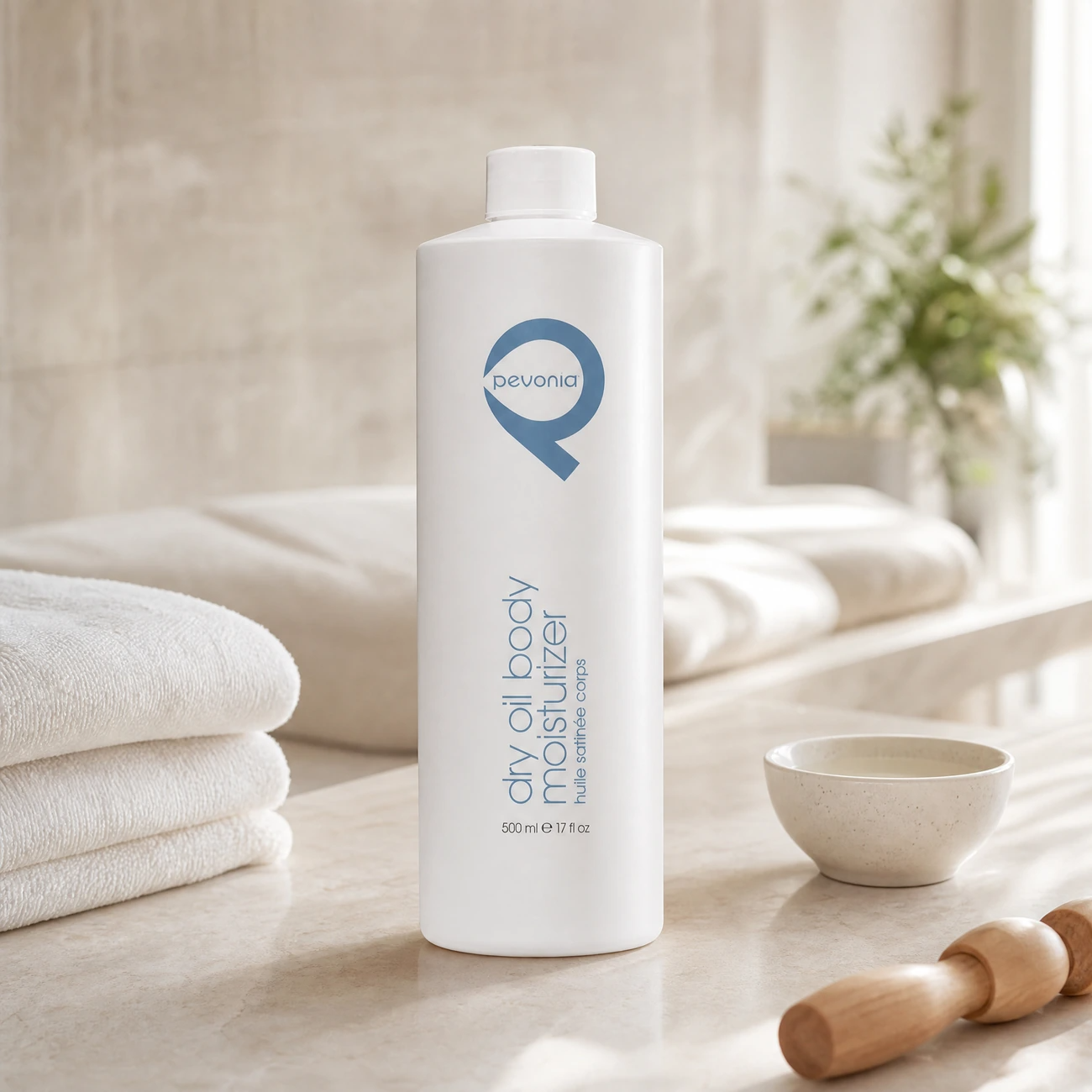 Pevonia Dry Oil Body Moisturiser 500ml professional tall white bottle styled in a serene clinical spa body treatment room for Beauty Collective Pro.
