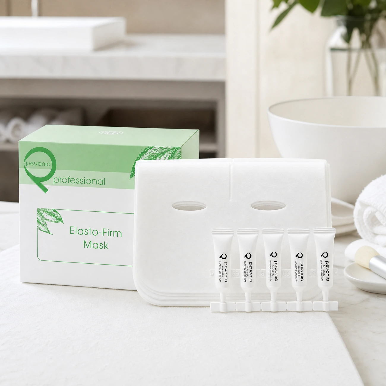 Pevonia Elasto-Firm Mask Treatment 5-pack box, dry collagen sheet masks, and Elastin ampoules styled in a serene clinical spa treatment room for Beauty Collective Pro.