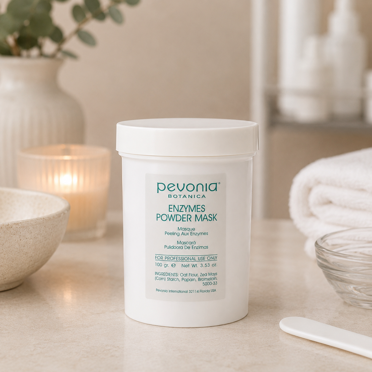 Pevonia Enzymes Powder Mask 100g jar displayed in a day spa facial treatment room with unbranded mask treatment accessories.