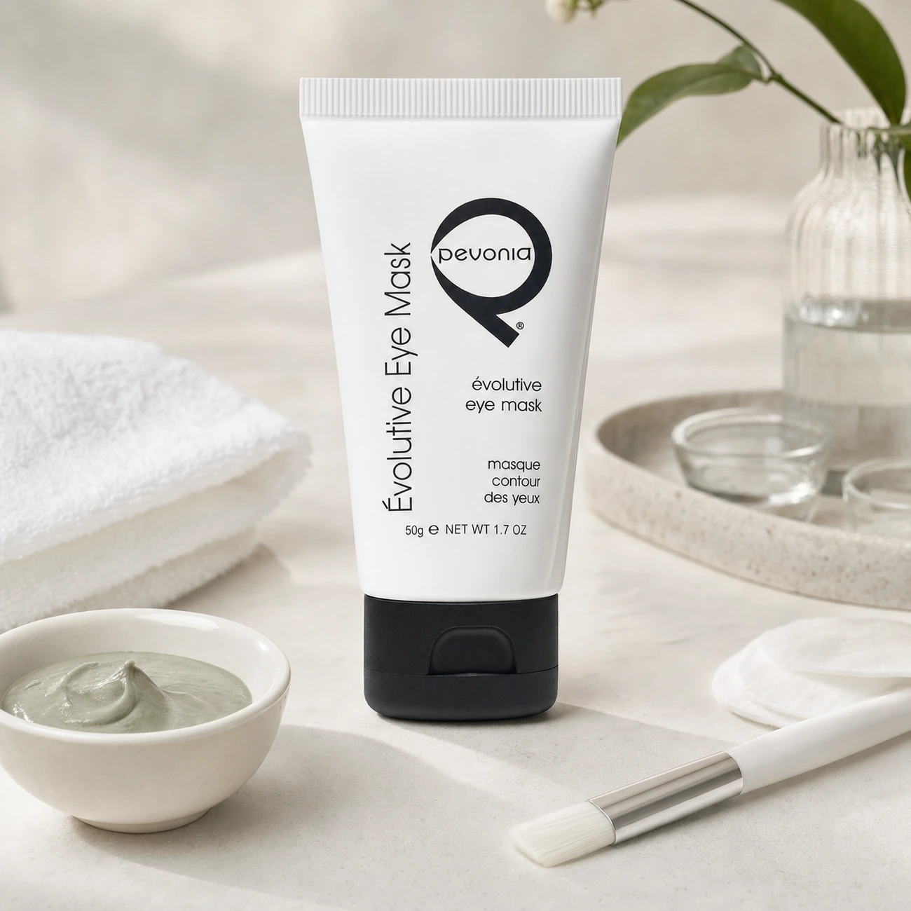 Pevonia Évolutive Eye Mask 50g professional tube styled in a clean clinic treatment setting for Beauty Collective Pro.