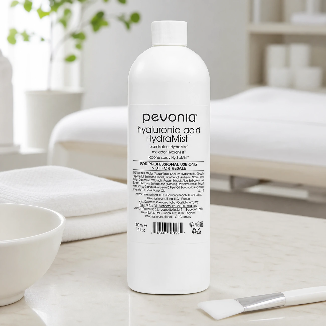 Pevonia Hyaluronic Acid HydraMist 500ml professional tall white bottle styled in a serene clinical spa treatment room for Beauty Collective Pro.