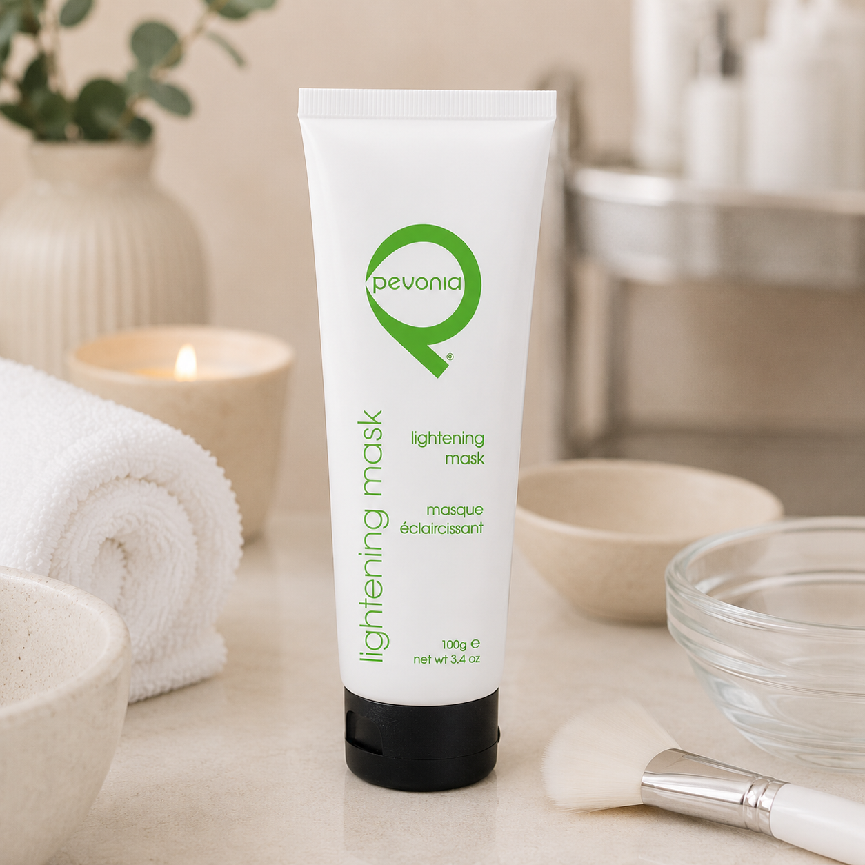 Pevonia Lightening Mask 100g tube displayed in a day spa facial treatment room with unbranded mask treatment accessories.