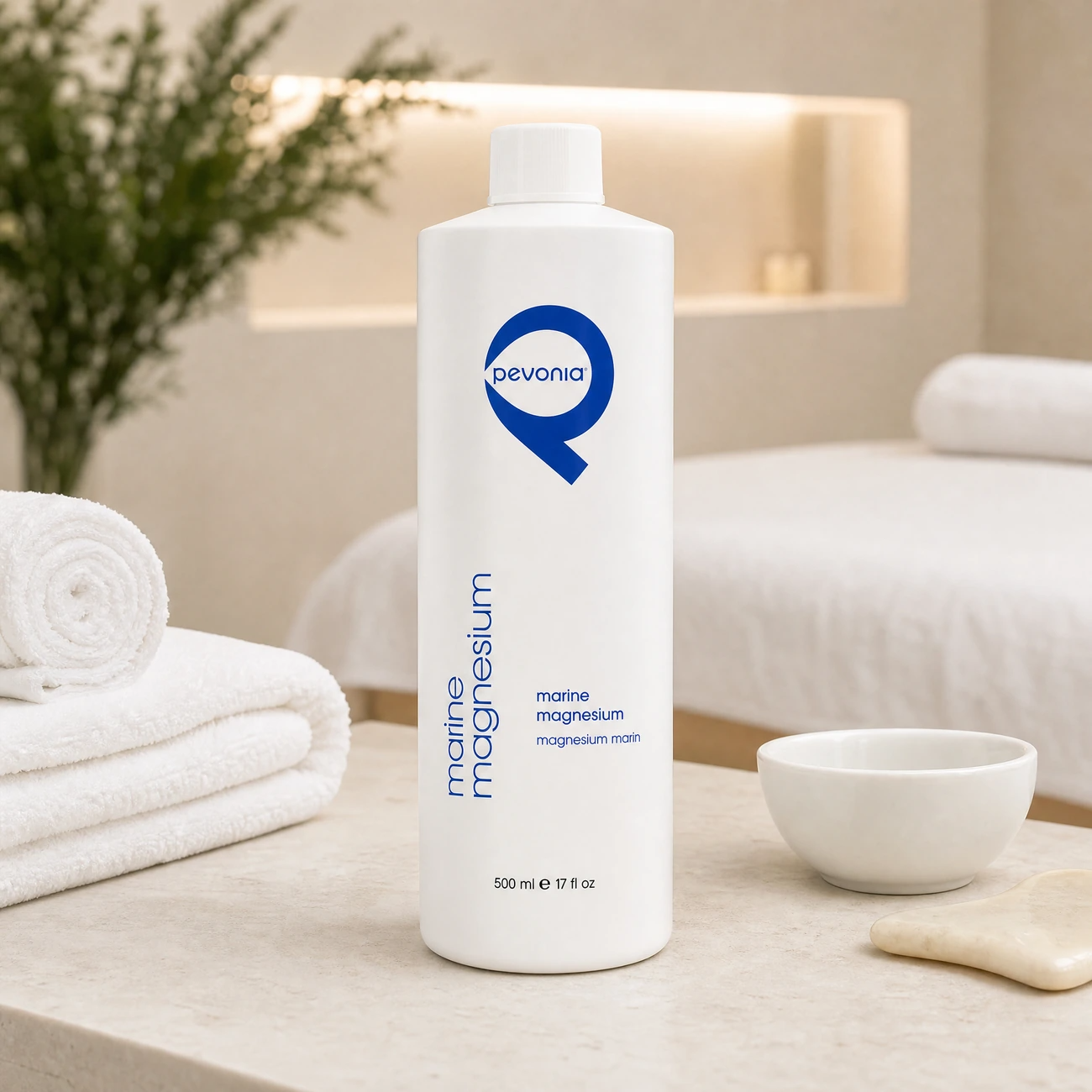 Pevonia Marine Magnesium 500ml professional tall white bottle styled in a serene clinical spa treatment room for Beauty Collective Pro.
