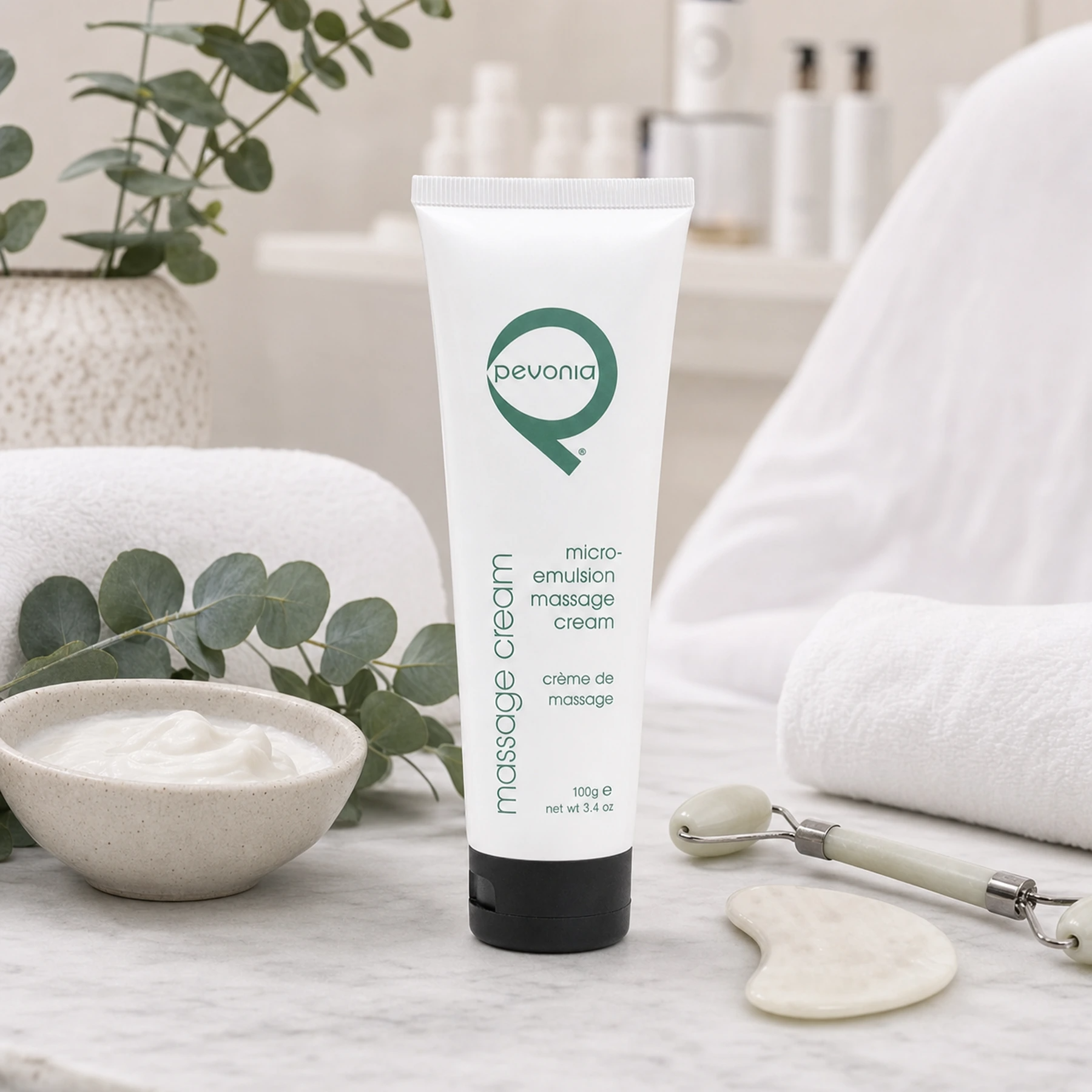 Pevonia Micro-Emulsion Massage Cream 100ml styled in a realistic professional facial massage treatment setting for Beauty Collective Pro.