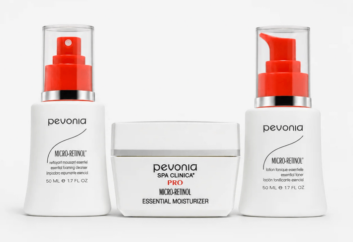 Three Pevonia Micro Retinol skincare products arranged side by side on a light gray background: a left pump bottle with a red cap, a center jar labeled 'Pevonia Spa Clinica Pro Micro Retinol Essential Moisturizer,' and a right pump bottle with a red spout.