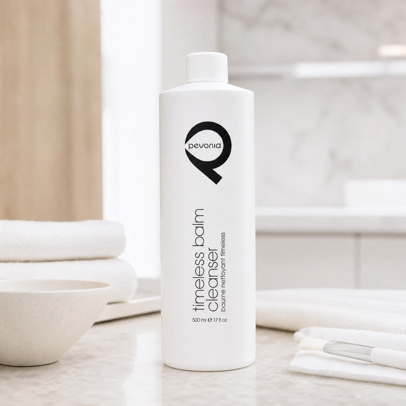 Pevonia Myoxy-Caviar Timeless Balm Cleanser 500ml professional tall white bottle styled in a serene clinical spa treatment room for Beauty Collective Pro.