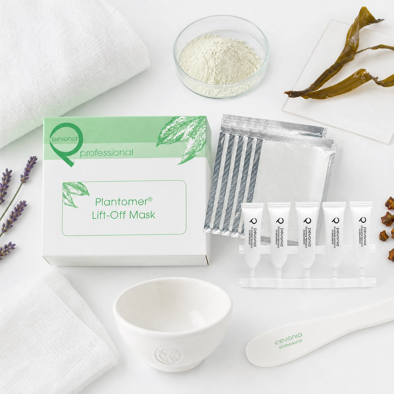 Pevonia Plantomer Lift-Off Mask Treatment 5pk treatment-support flatlay with alginate powder, seaweed, propolis, lavender and professional mask tools.