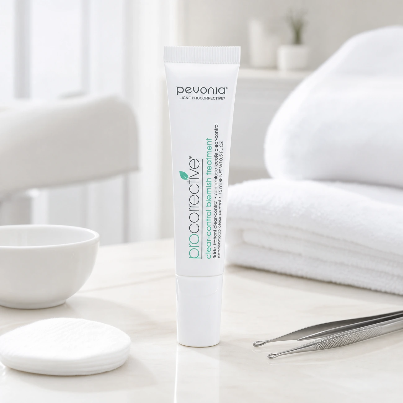 Pevonia ProCorrective Clear-Control Blemish Treatment 15ml professional white tube styled in a serene clinical spa treatment room for Beauty Collective Pro.