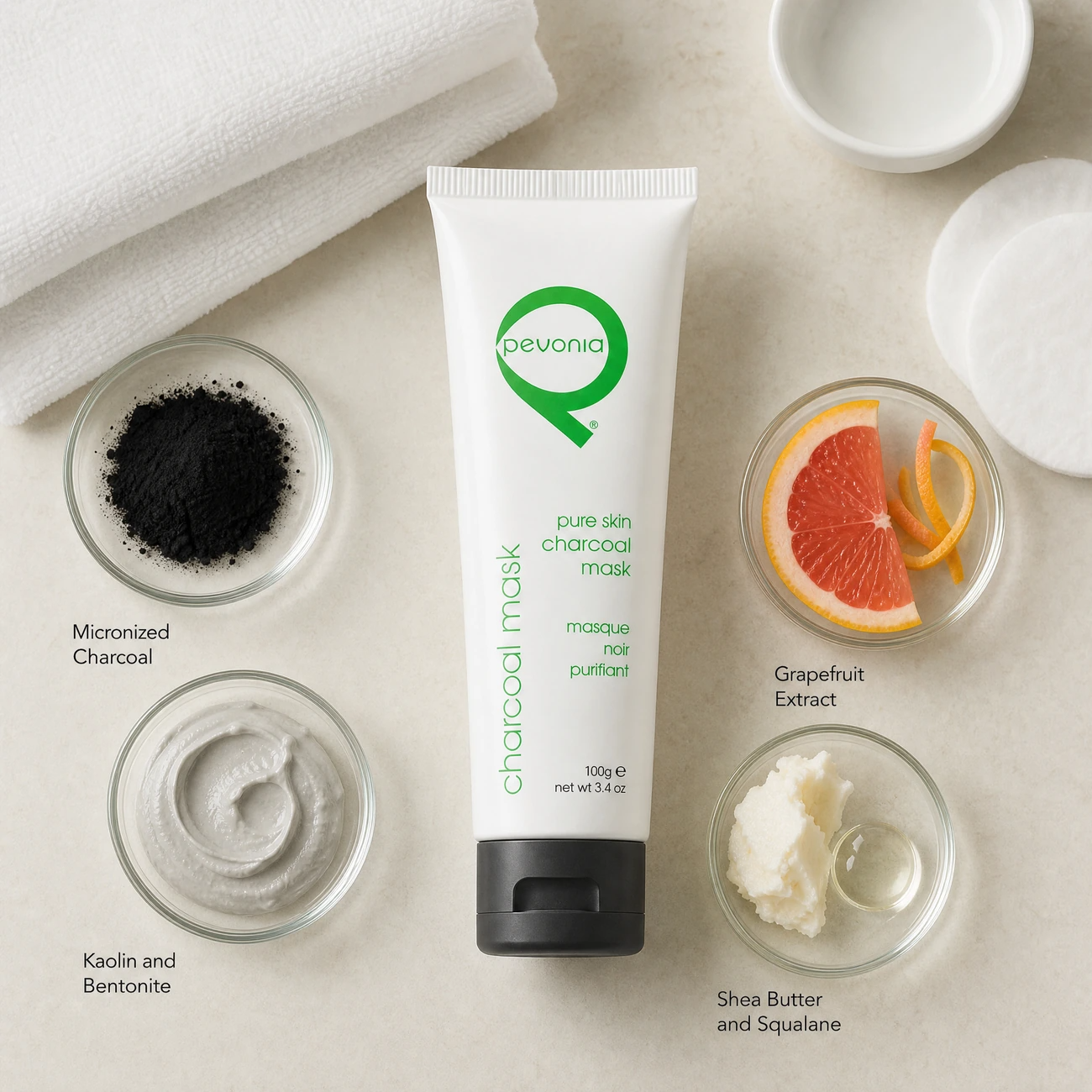 Pevonia Pure Skin Charcoal Mask 100ml ingredients flatlay with micronized charcoal, kaolin and bentonite clay, grapefruit extract, and shea butter in clean glass petri dishes for professional B2B education.