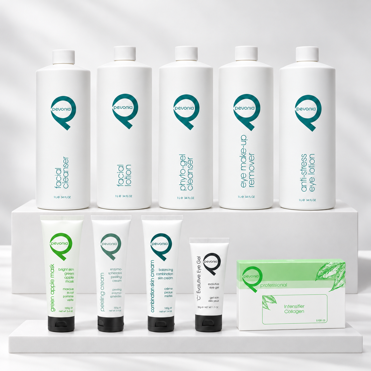 Complete Pevonia Radiance Bright Skin Green Apple professional treatment collection arranged on white display tiers, including Green Apple Mask, Balancing Combination Skin Cream and the professional Collagen Intensifier ampoule box.