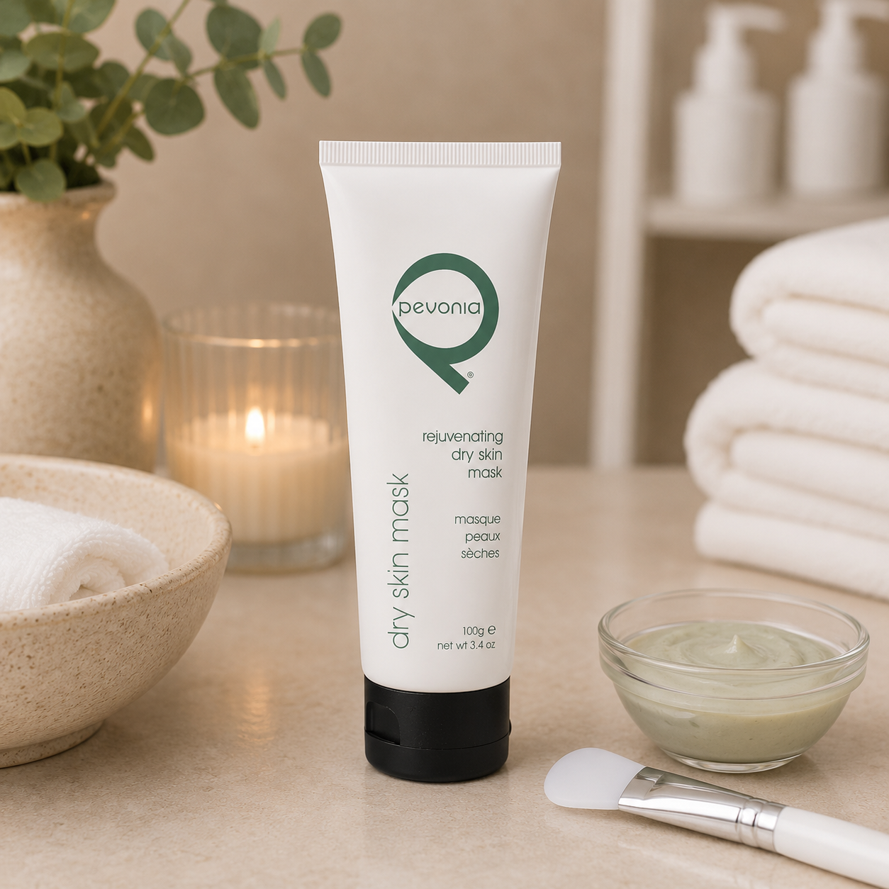 Pevonia Rejuvenating Dry Skin Mask 100g tube displayed in a day spa facial treatment room with unbranded mask treatment accessories.