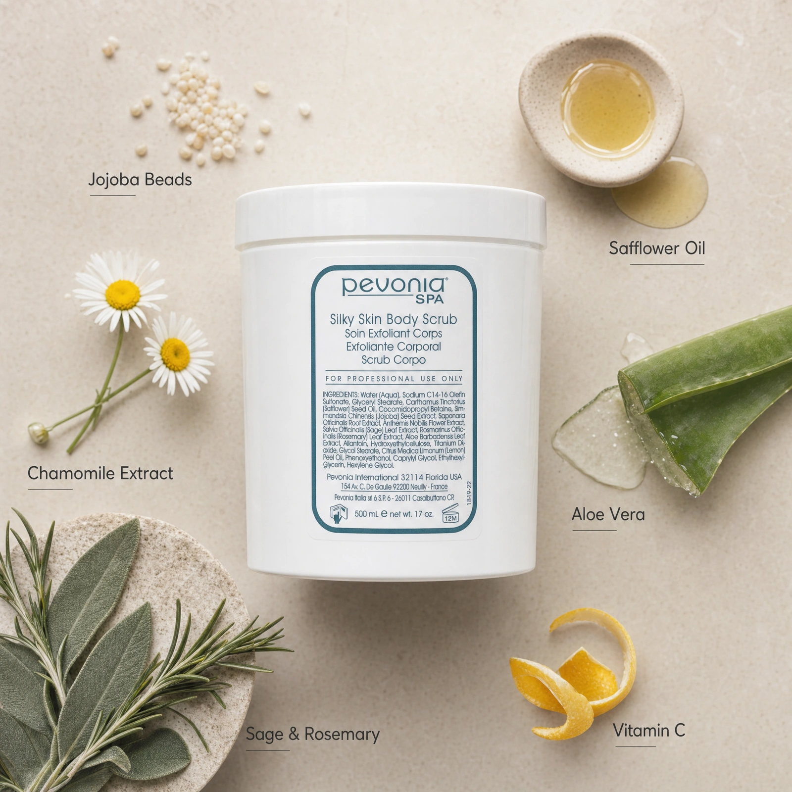 Pevonia Spa Silky Skin Body Scrub 500ml ingredient flatlay with Jojoba Beads, Safflower Oil, Chamomile Extract, Aloe Vera, Sage and Rosemary, and Vitamin C.