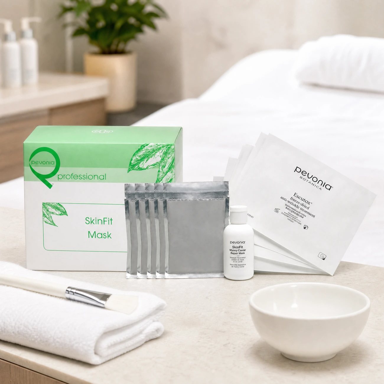 Pevonia SkinFit Mask Treatment 5-pack box, silver sachets, repair mask bottle, and Escutox sachets styled in a premium clinical treatment room for Beauty Collective Pro.