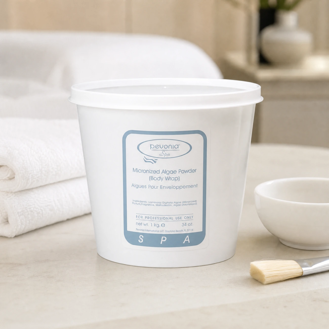 Pevonia Spa Micronized Algae Powder Body Wrap 1kg professional tub with classic grey-blue label styled in a serene clinical spa treatment room for Beauty Collective Pro.