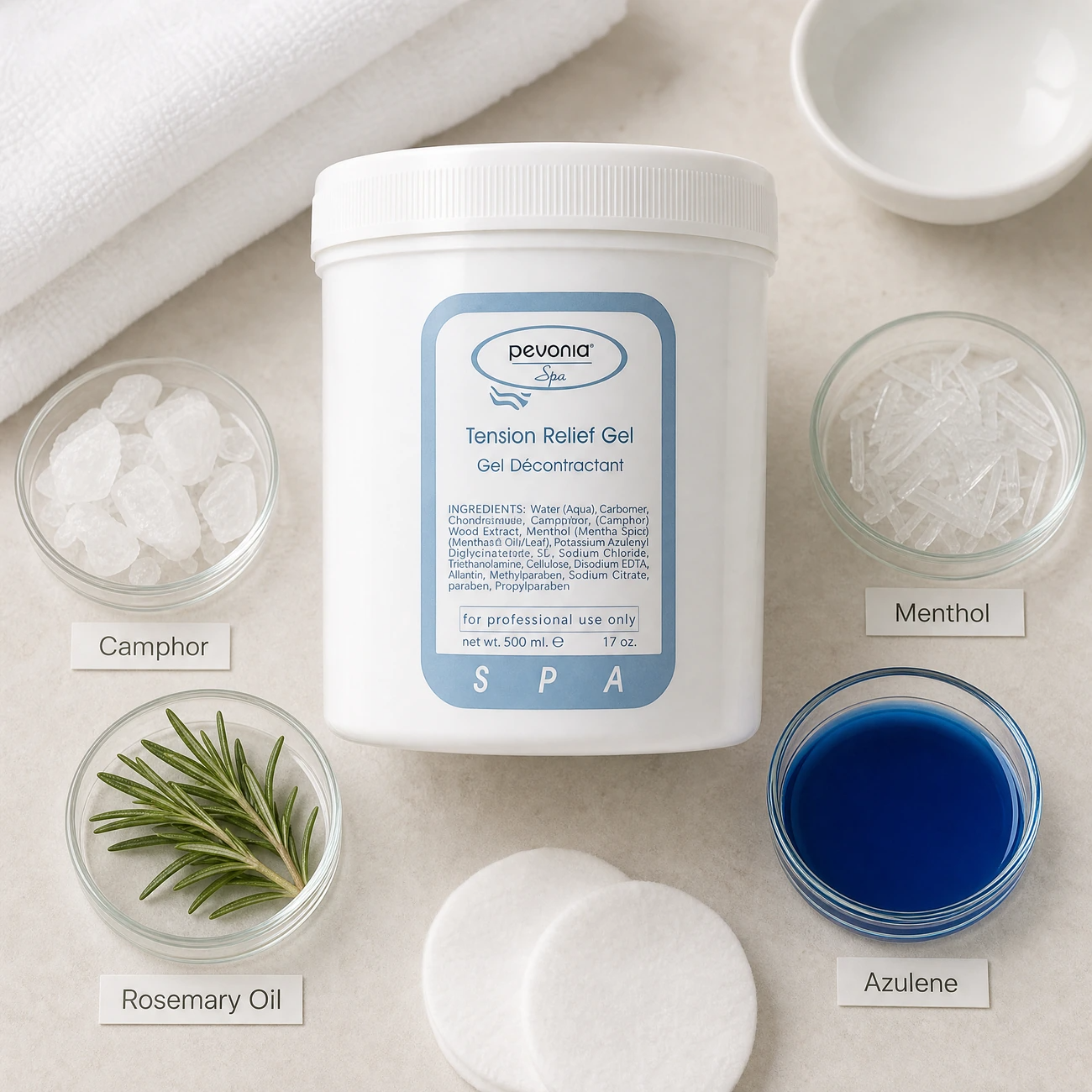 Pevonia Spa Tension Relief Gel 500ml ingredients flatlay with camphor, menthol crystals, rosemary sprigs, and deep blue azulene in clean glass petri dishes for professional B2B education.