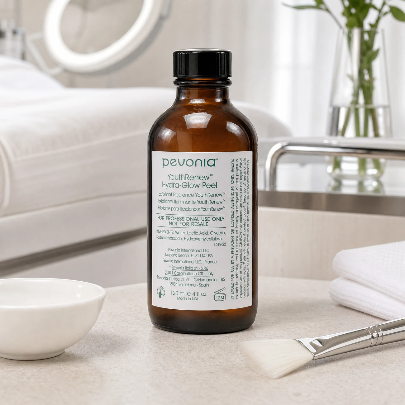 Pevonia YouthRenew Hydra-Glow Peel 120ml professional amber glass bottle styled in a serene clinical spa treatment room for Beauty Collective Pro.