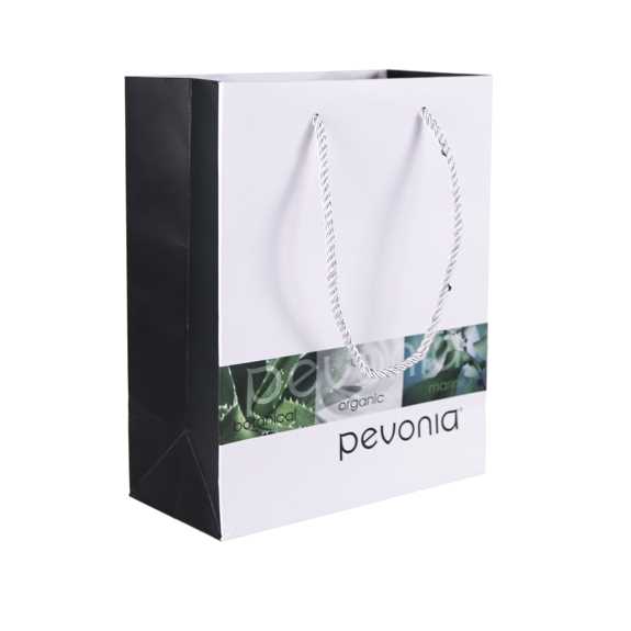 A Pevonia branded paper bag with black and white design elements, featuring the name 'pevonia' in lowercase on the side.