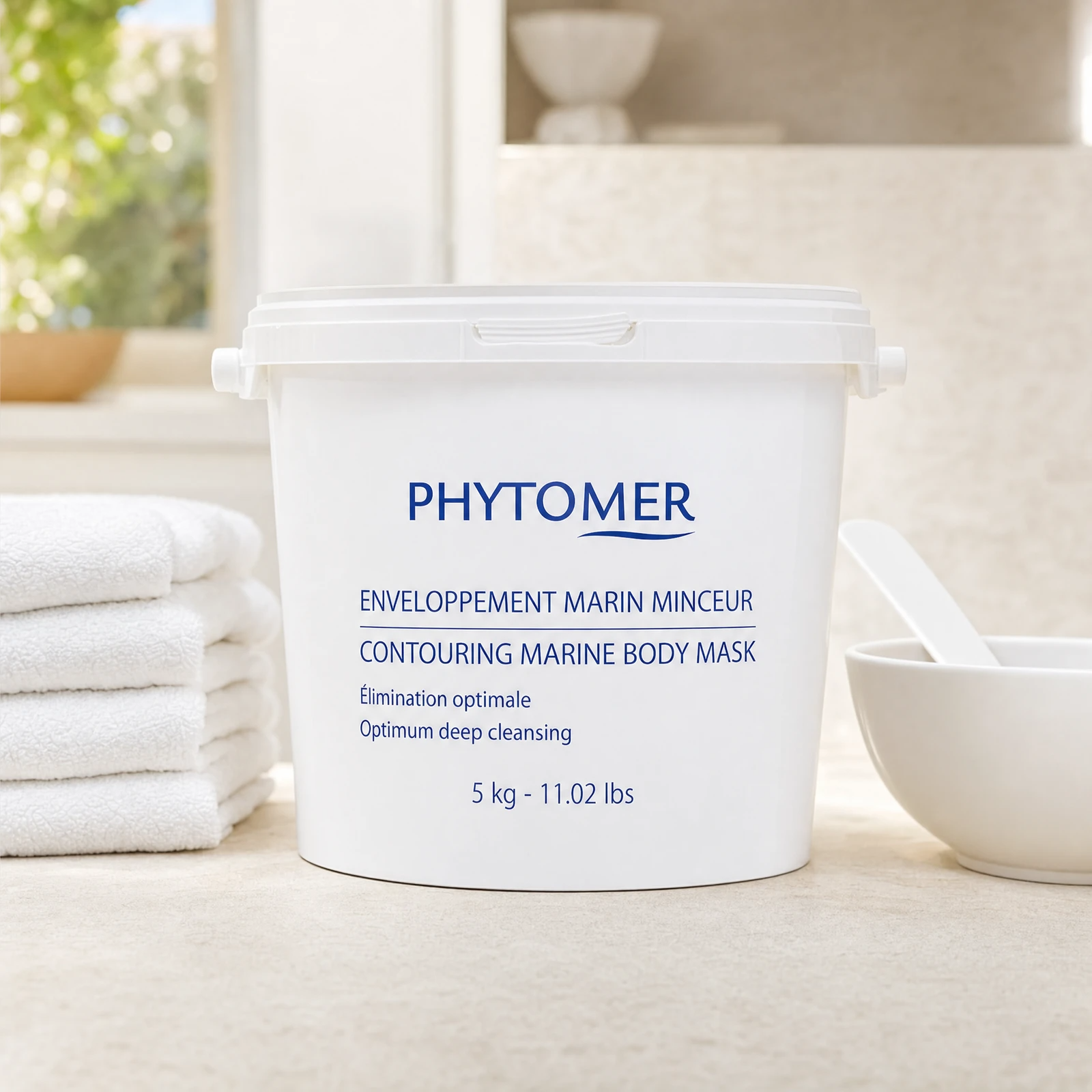 Phytomer Contouring Marine Body Mask 5kg professional bucket on a premium spa body wrap treatment stone counter with white towels and ceramic mixing bowl