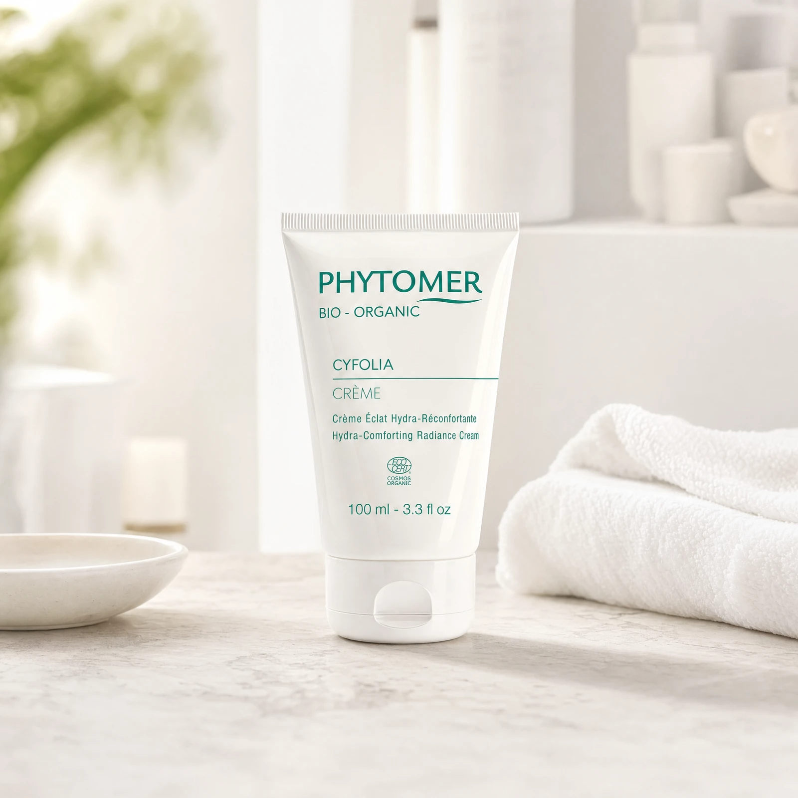 Phytomer Cyfolia Organic Hydra-Comforting Radiance Cream 100ml professional tube on a premium beauty clinic marble counter with white spa towels and ceramic dish