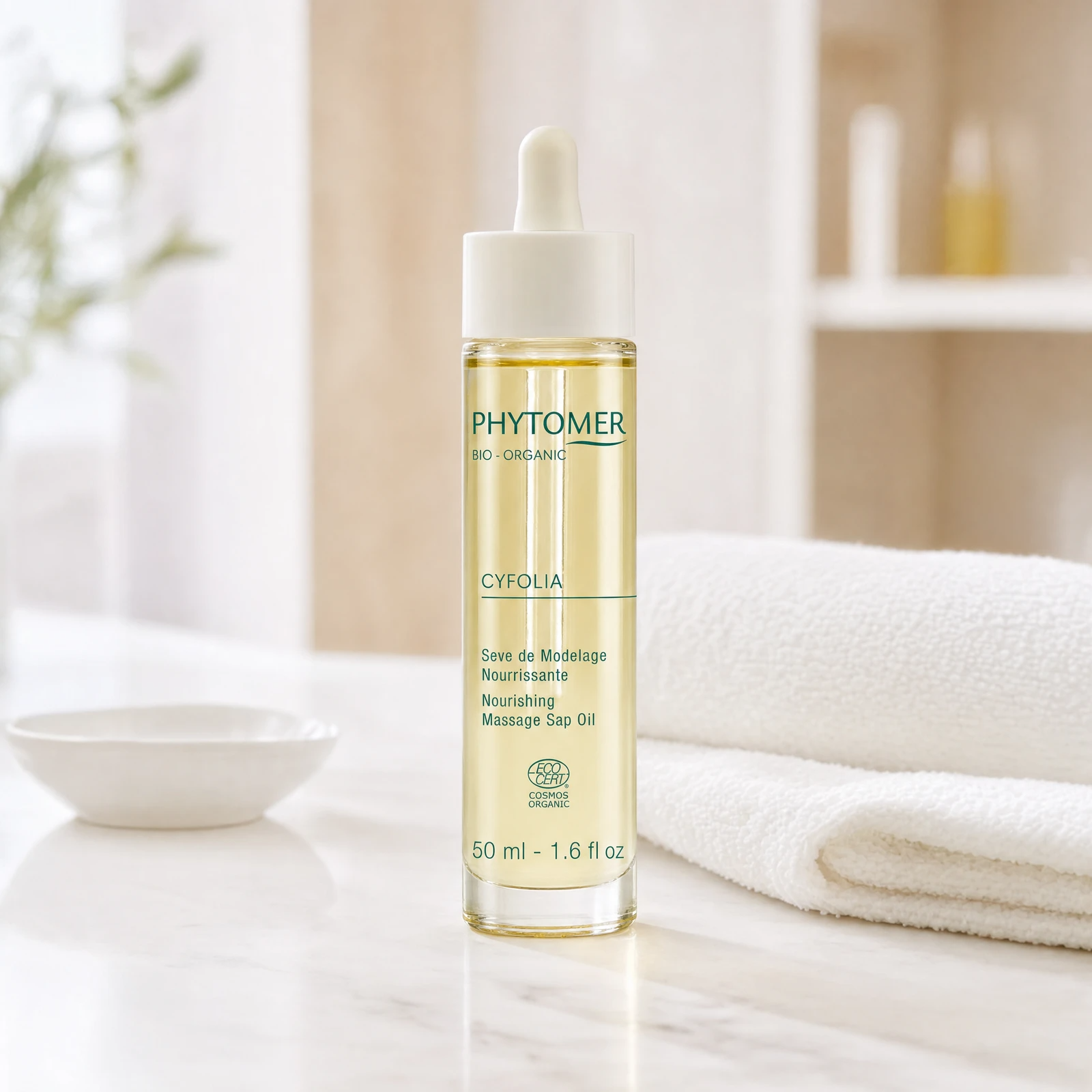 Phytomer Cyfolia Organic Nourishing Massage Sap Oil 50ml golden dropper bottle on a premium beauty clinic marble counter with white spa towels and ceramic dish