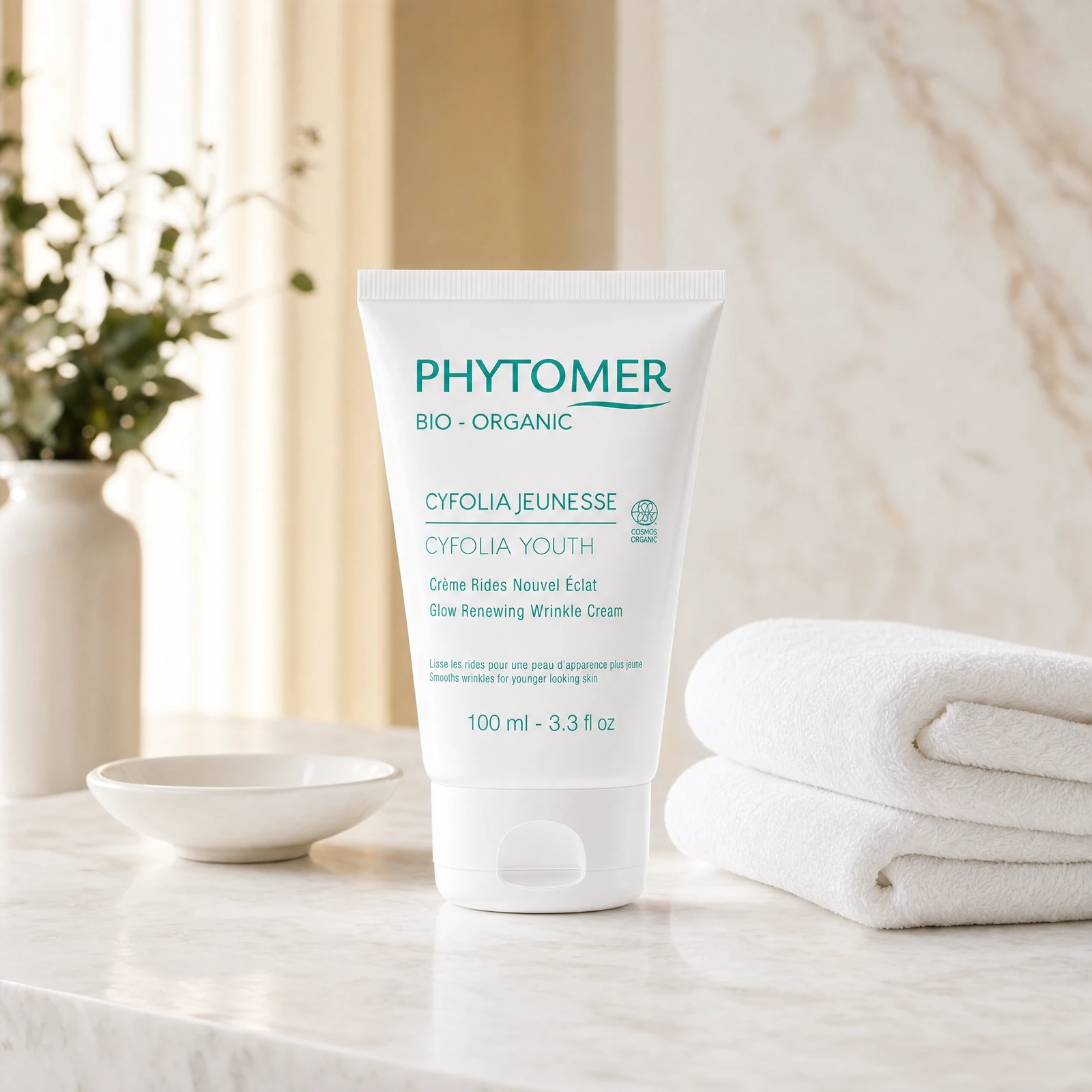 Phytomer Cyfolia Youth Glow Renewing Wrinkle Cream 100ml professional tube on a premium beauty clinic marble counter with white spa towels and ceramic dish