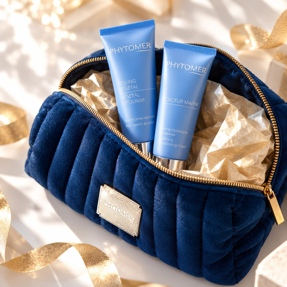 PHYTOMER Douceur Marine cream and Vegetal Exfoliant revealed inside a blue cosmetics pouch with gold ribbon.