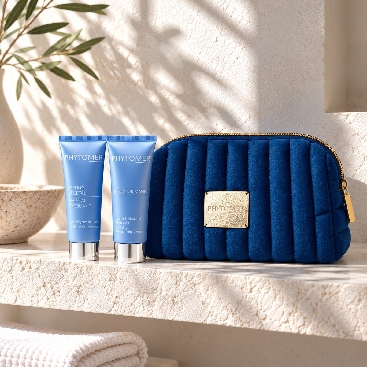 PHYTOMER Douceur Marine Ritual Gift Set with two blue skincare tubes and matching cosmetics pouch on a spa shelf.