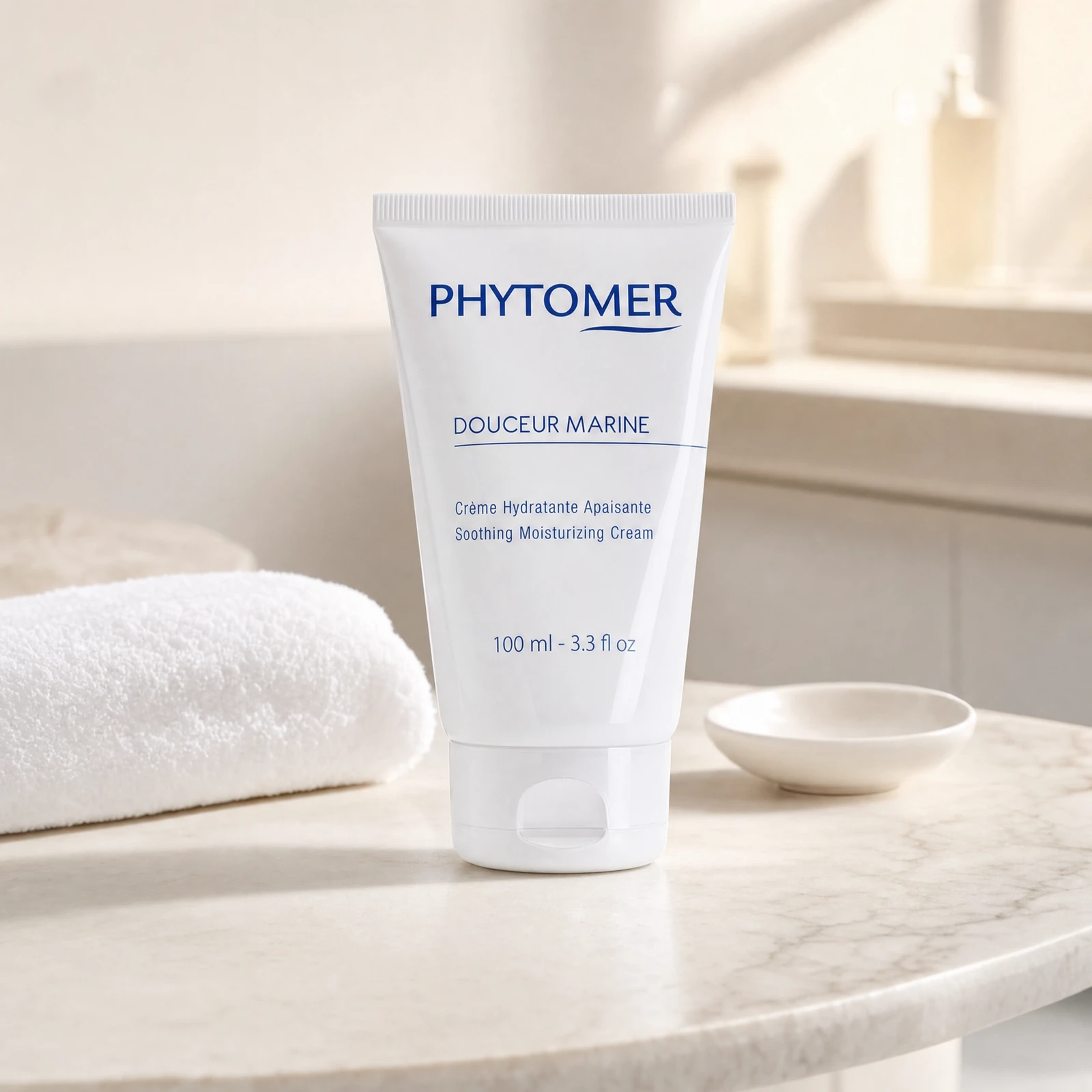 Phytomer Douceur Marine Soothing Moisturizing Cream 100ml professional tube on a premium beauty clinic marble counter with white spa towels and ceramic dish