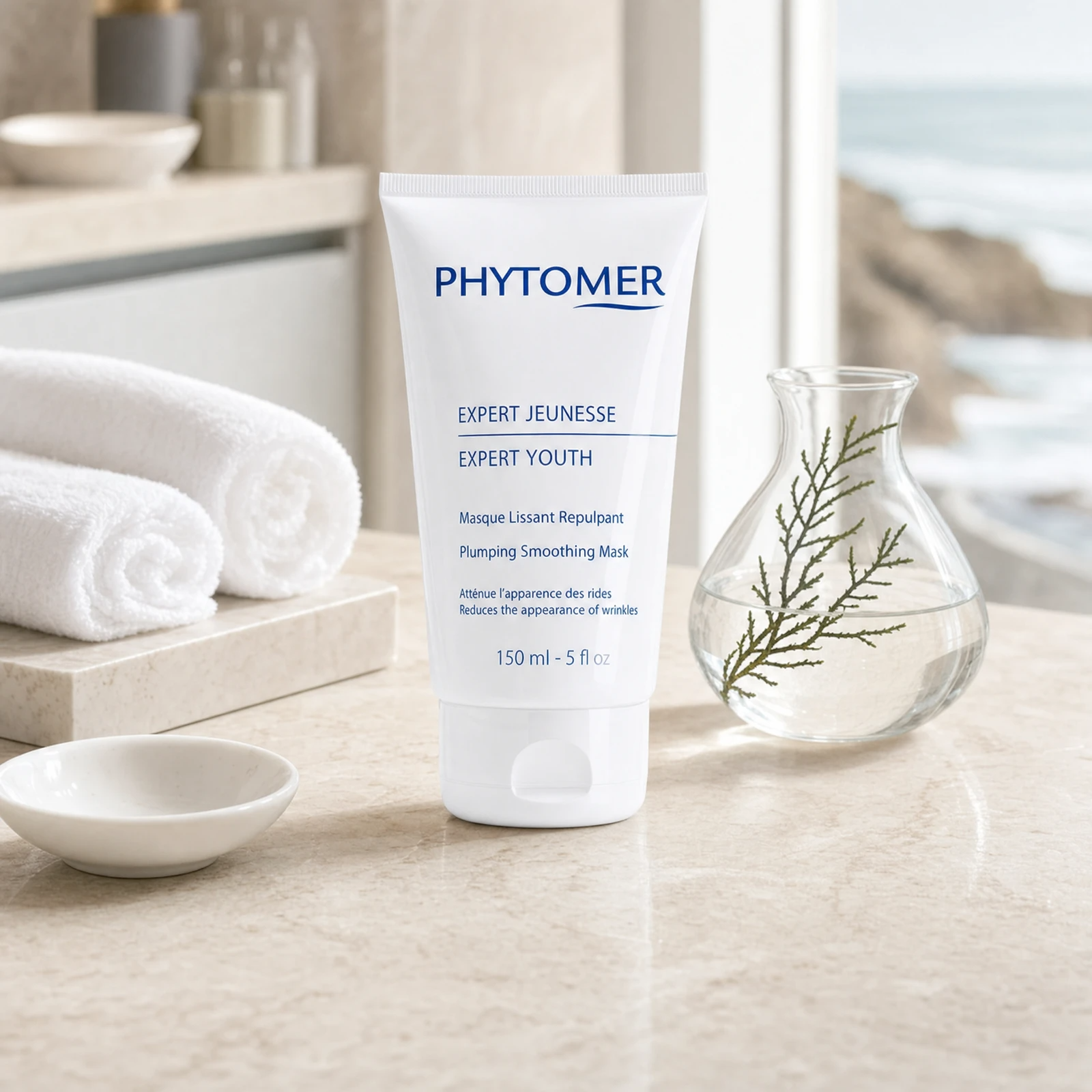Phytomer Expert Youth Plumping Smoothing Mask 150ml on a marble spa treatment counter with white towels and glass vessel, professional clinic setting