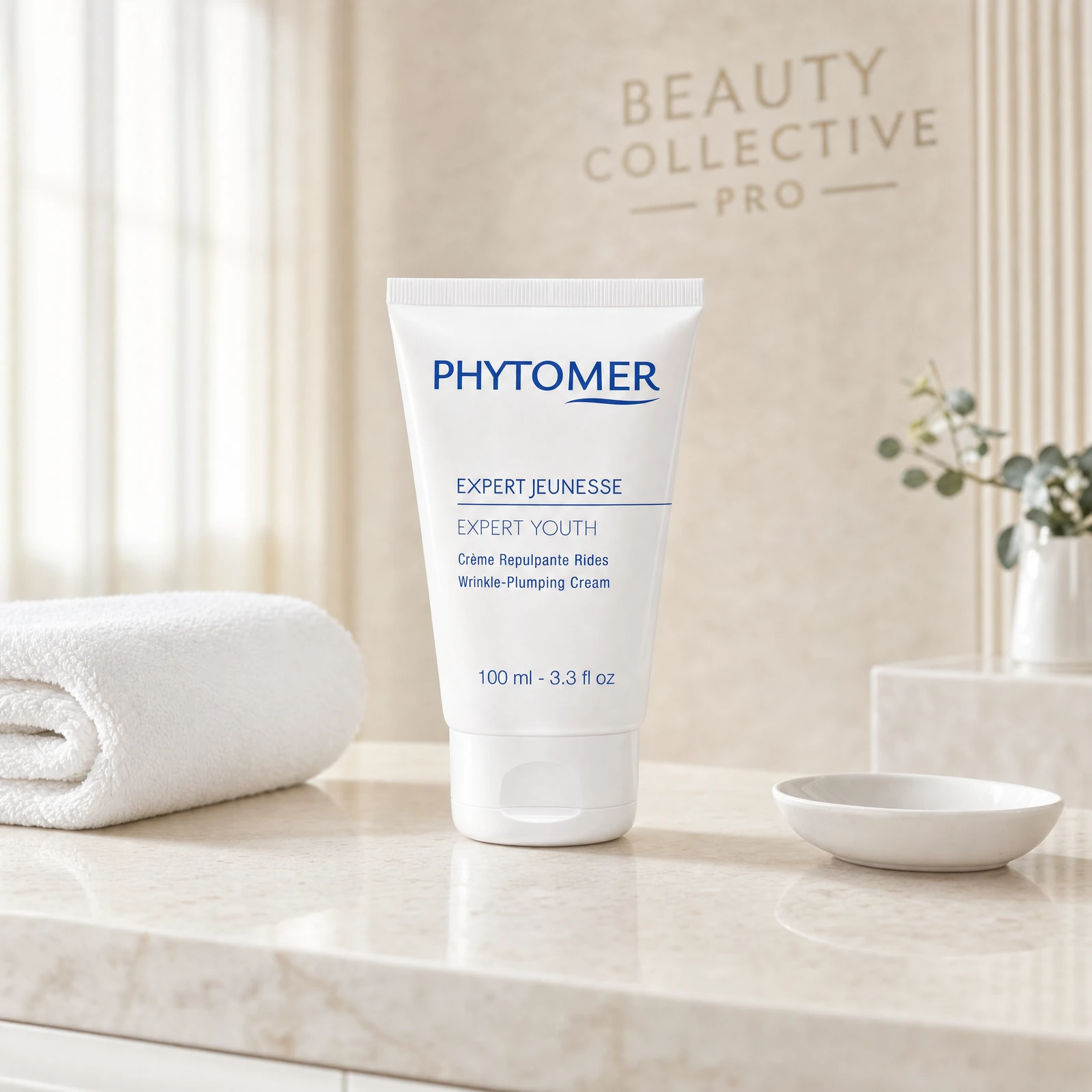 Phytomer Expert Youth Wrinkle-Plumping Cream 100ml professional tube on a premium beauty clinic treatment counter with white spa towel and ceramic dish