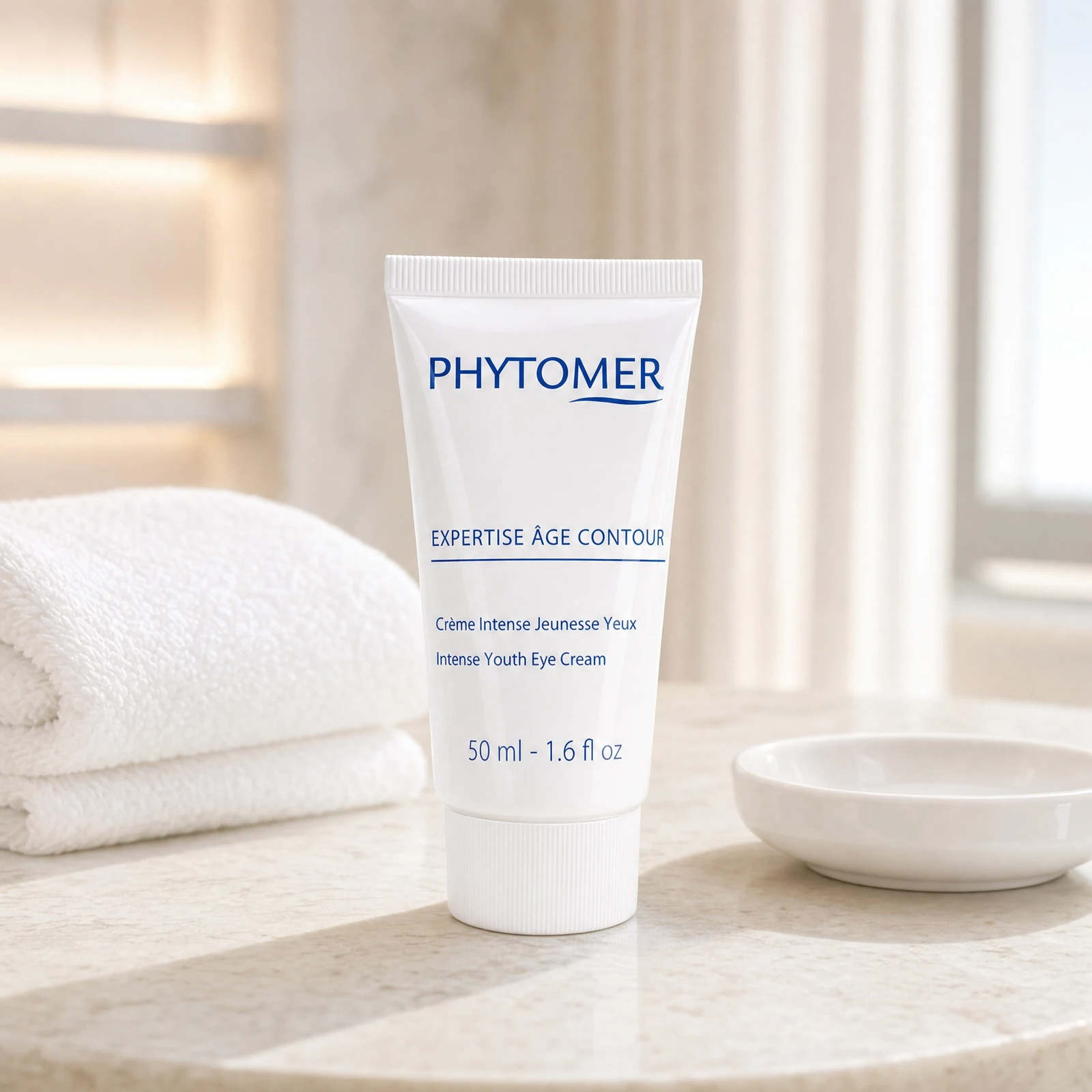 Phytomer Expertise Age Contour Intense Youth Eye Cream 50ml professional tube on a premium beauty clinic marble counter with white spa towels and ceramic dish