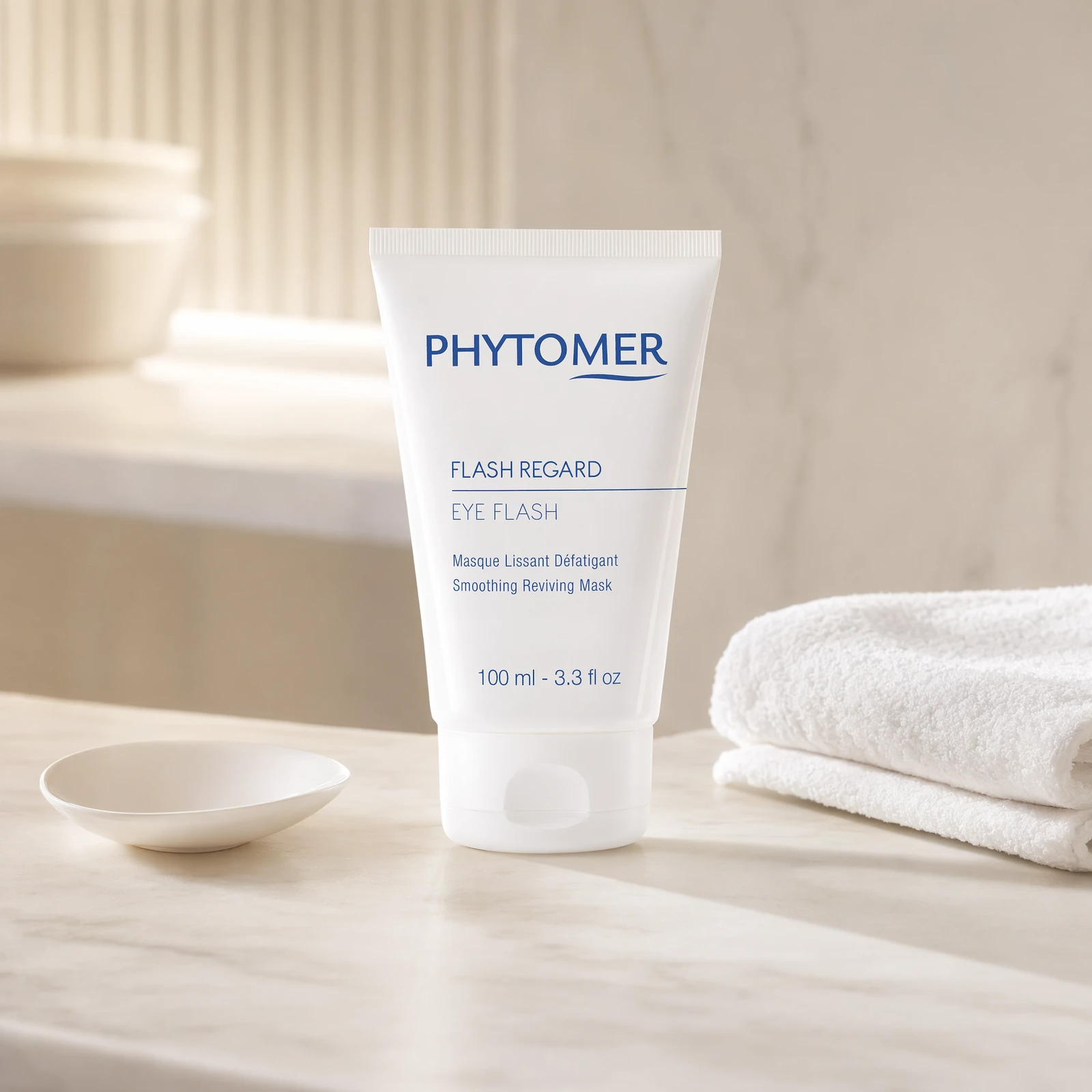 Phytomer Eye Flash Smoothing Reviving Mask 100ml professional tube on a premium beauty clinic marble counter with white spa towels and ceramic dish