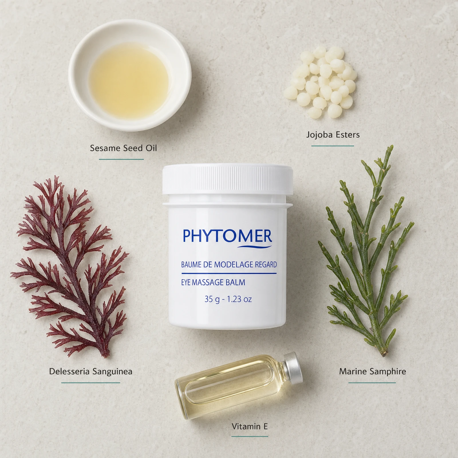 Phytomer Eye Massage Balm 35g flatlay with key ingredients including Sesame Seed Oil, Jojoba Esters, Delesseria Sanguinea red algae, Marine Samphire and Vitamin E