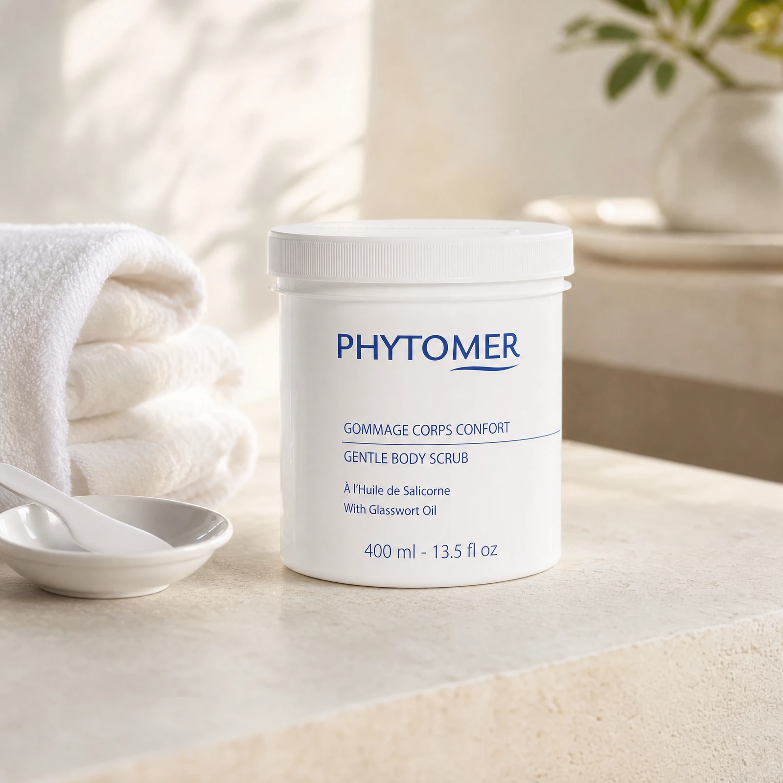 Phytomer Gentle Body Scrub with Glasswort Oil 400ml professional tub on a premium spa body exfoliation treatment stone counter with white towels and ceramic spatula