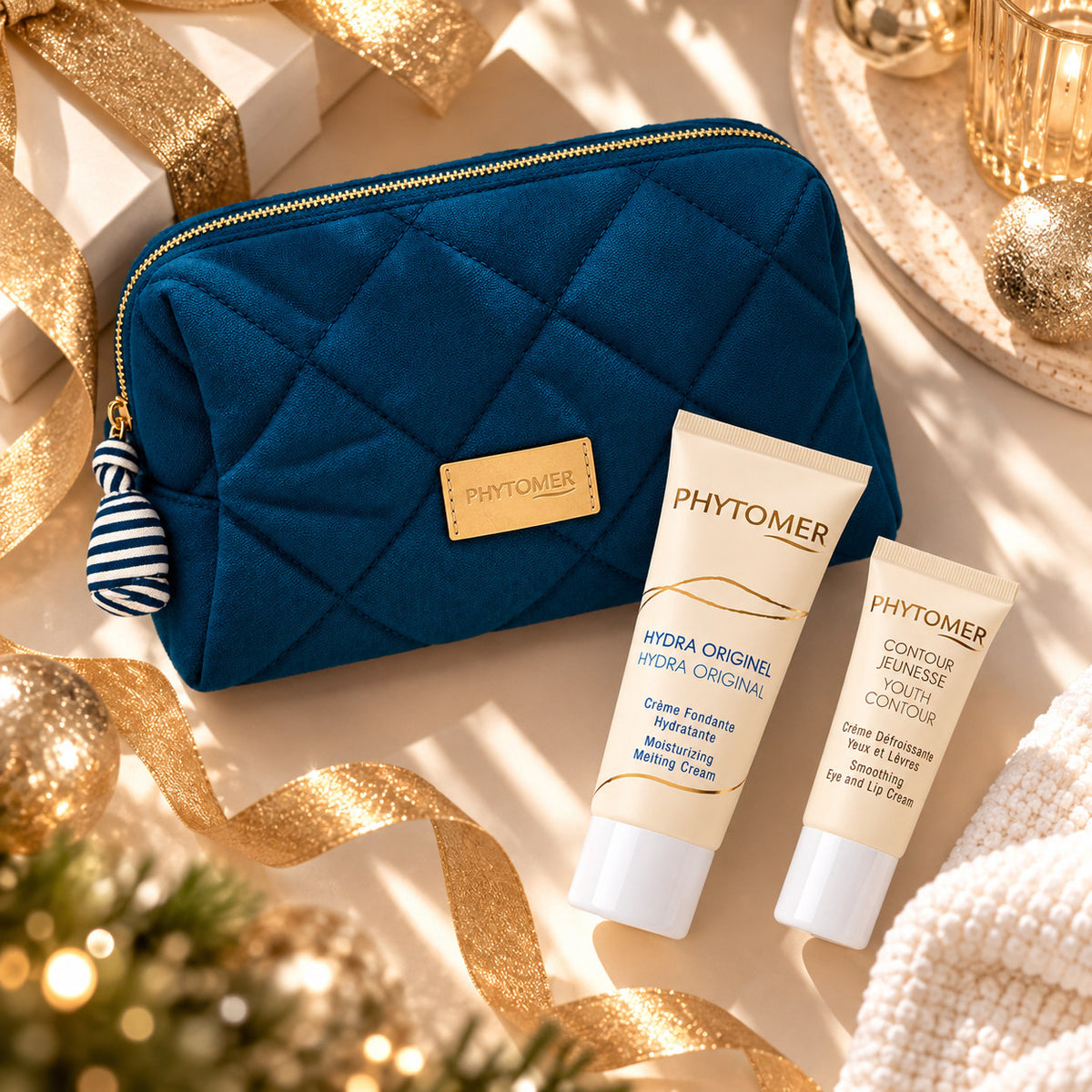 PHYTOMER Hydra Original Ritual Gift Set Christmas flat lay with blue quilted pouch, Hydra Original cream and Youth Contour Eye and Lip Cream.