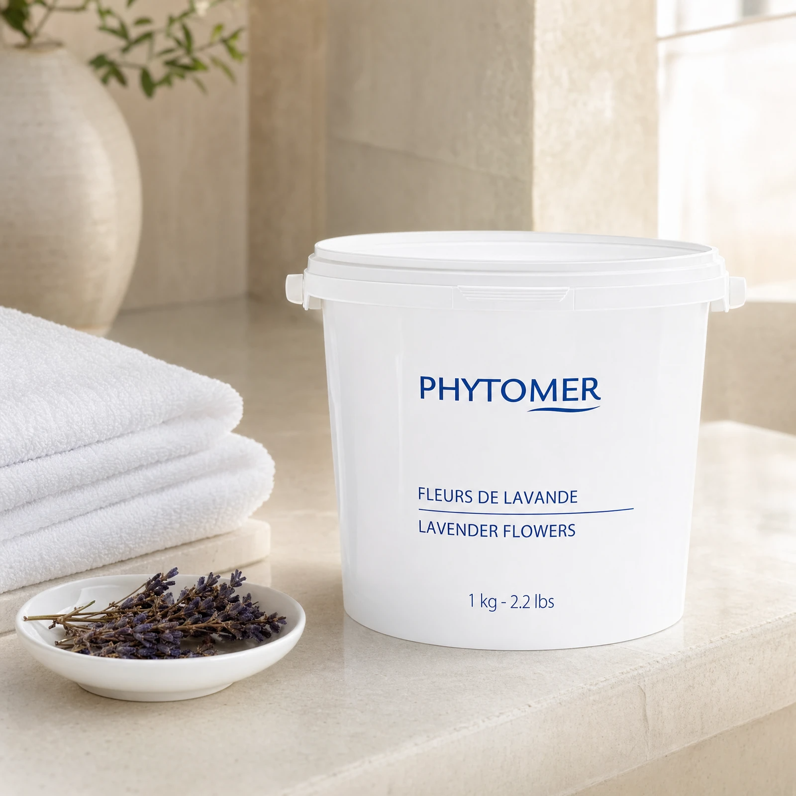 Phytomer lavender flowers container on a neutral background with towels and lavender buds.