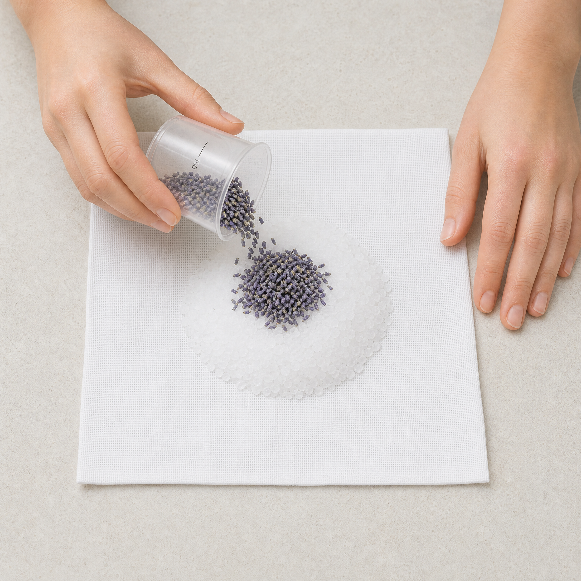 Therapist adding one level 100-line measure of Lavender Flowers over Marine Salt Crystals on a Phytomer Marine Bolus fabric square