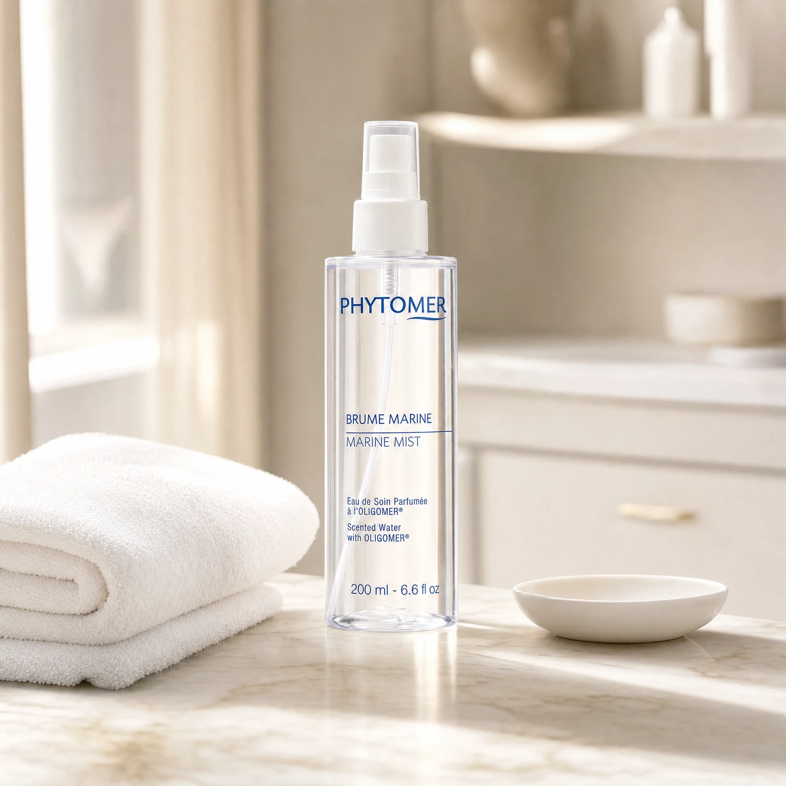 Phytomer Marine Mist Scented Water with Oligomer 200ml clear spray bottle on a premium beauty clinic marble counter with white spa towels and ceramic dish
