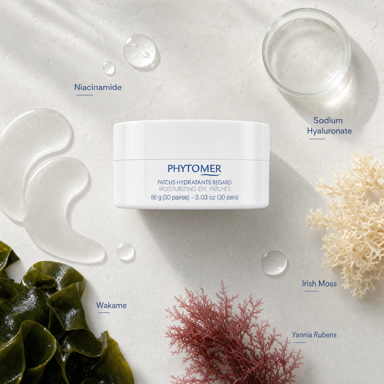Phytomer Moisturizing Eye Patches 30 pairs ingredient flatlay featuring niacinamide, sodium hyaluronate, Irish moss, wakame and yannia rubens.