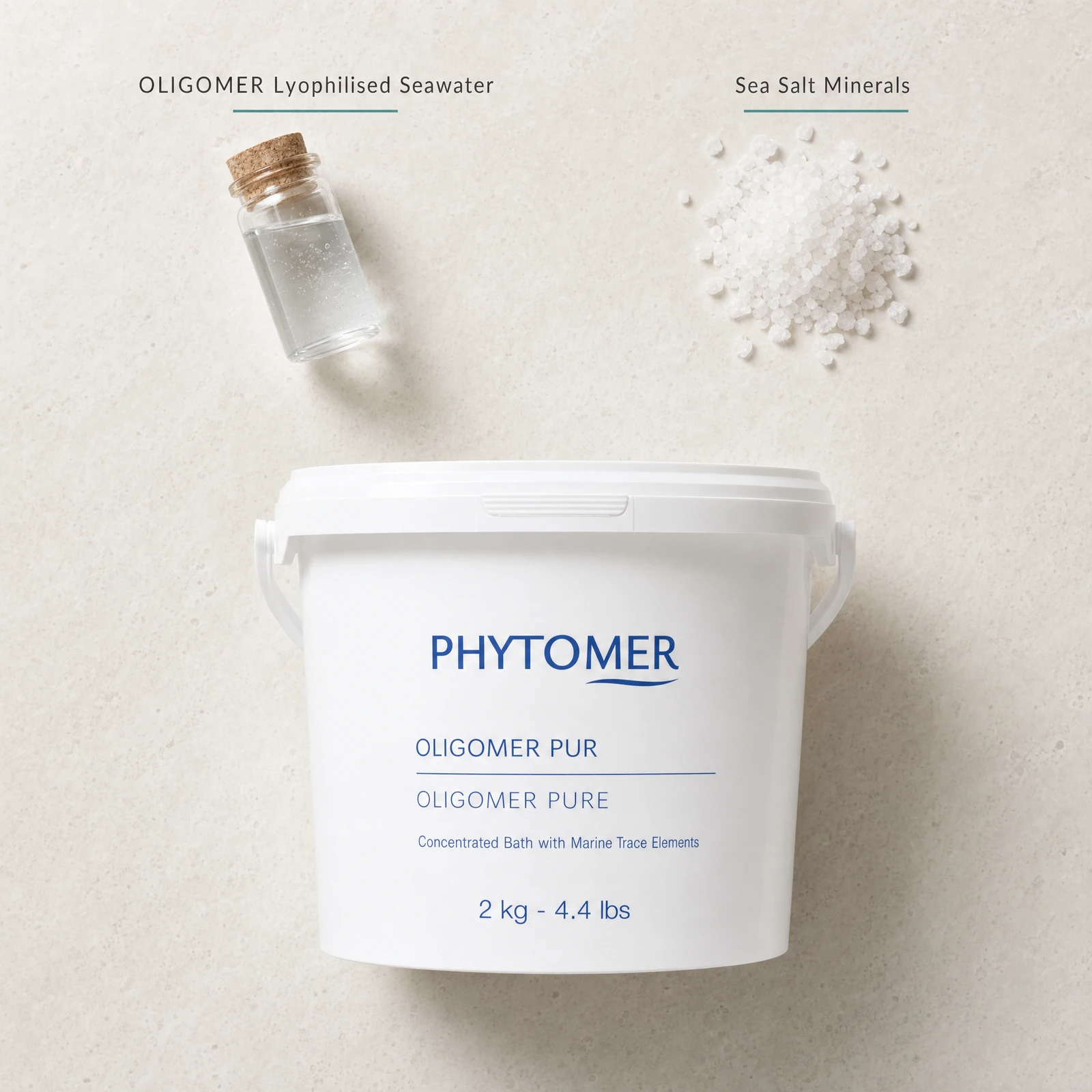 Phytomer Oligomer Pure Lyophilized Sea Water Bath 2kg flatlay on limestone surface with OLIGOMER Lyophilised Seawater and Sea Salt Minerals