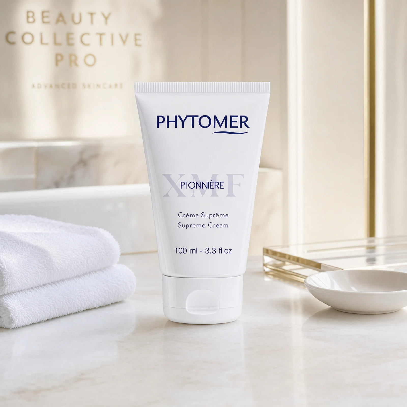 Phytomer Pionniere XMF Youth and Glow Supreme Cream 100ml professional tube on a luxury beauty clinic marble counter with white spa towels and ceramic dish
