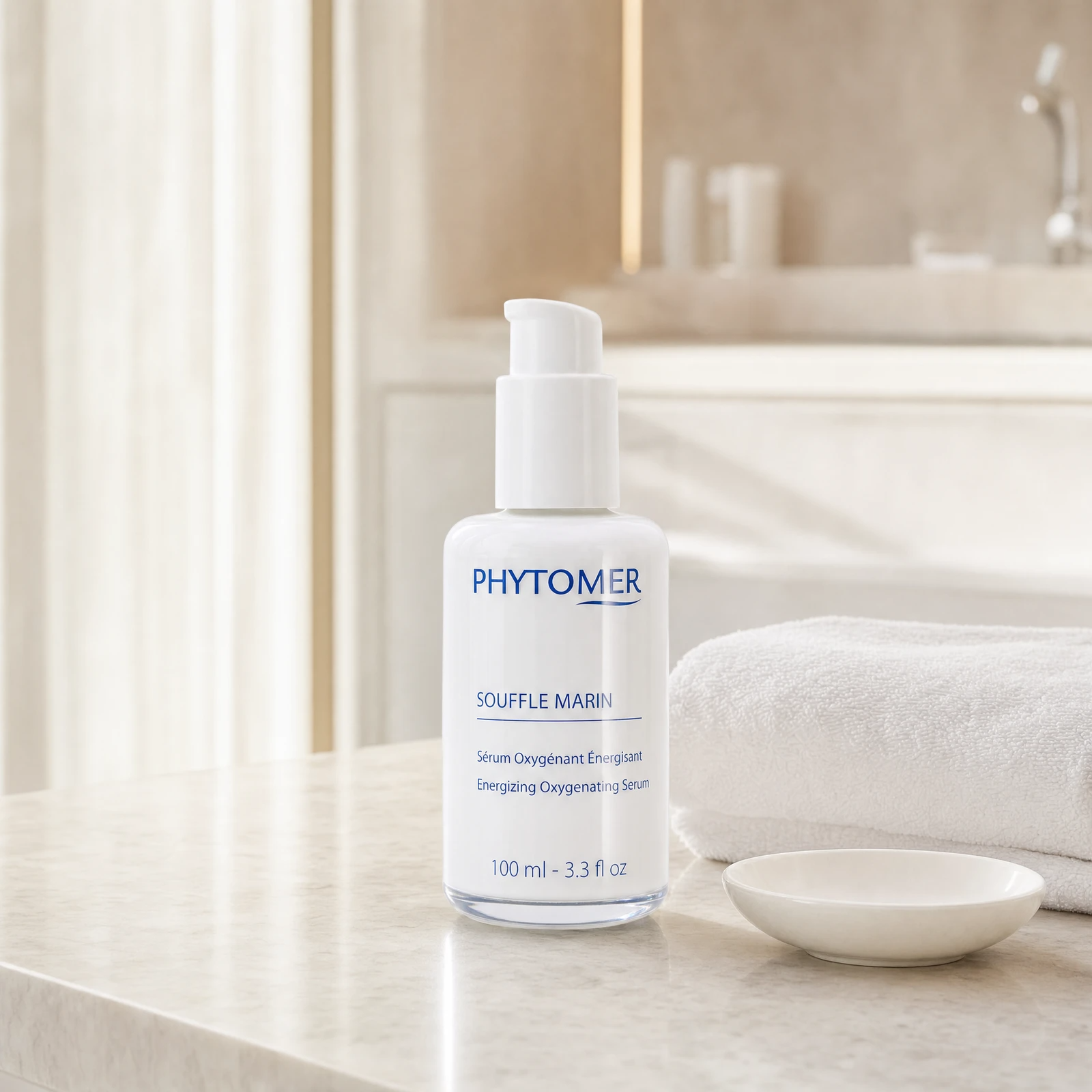 Phytomer Souffle Marin Energizing Oxygenating Serum 100ml pump bottle on a premium beauty clinic marble counter with white spa towels and ceramic dish