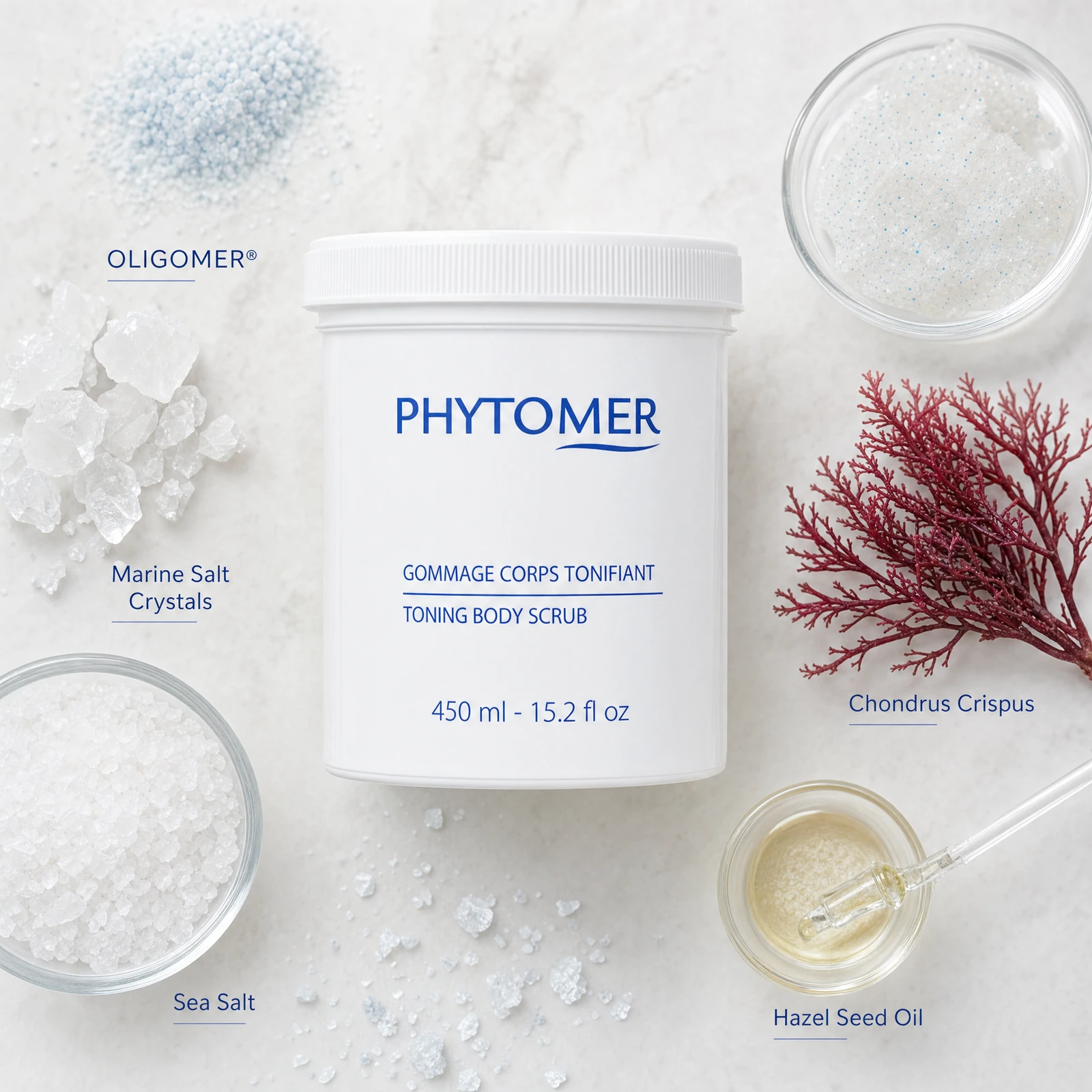 Phytomer Toning Body Scrub with Marine Salt Crystals 450ml ingredient flatlay featuring OLIGOMER, marine salt crystals, sea salt, chondrus crispus and hazel seed oil.