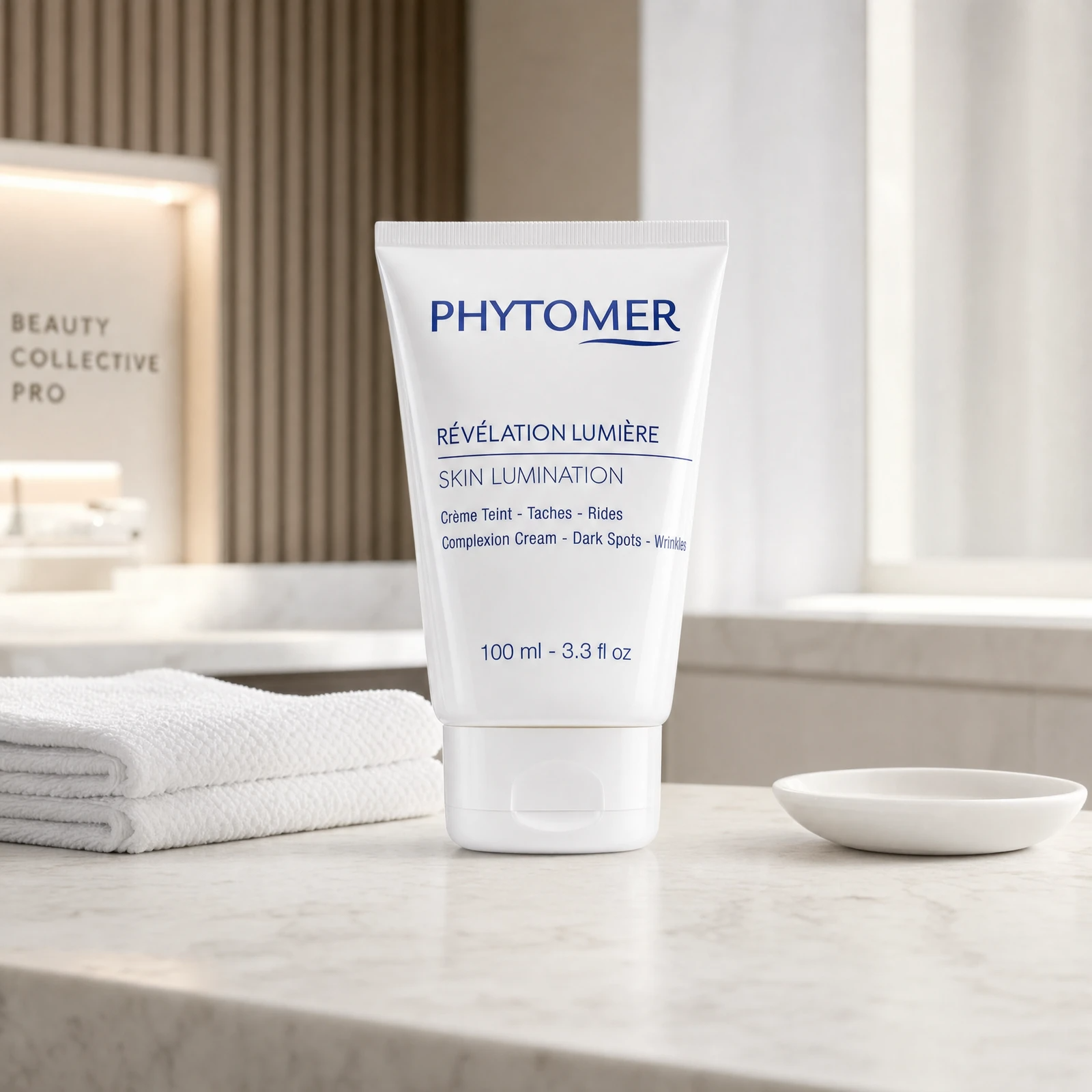 Phytomer White Lumination Complexion Cream 100ml professional tube on a premium beauty clinic marble counter with white spa towel and ceramic dish