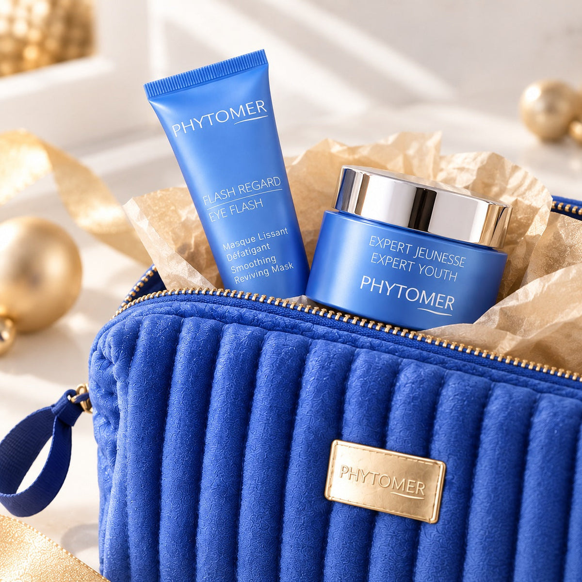 PHYTOMER Youth & Wrinkles Gift Set close-up with Expert Youth cream and Eye Flash emerging from blue cosmetics pouch