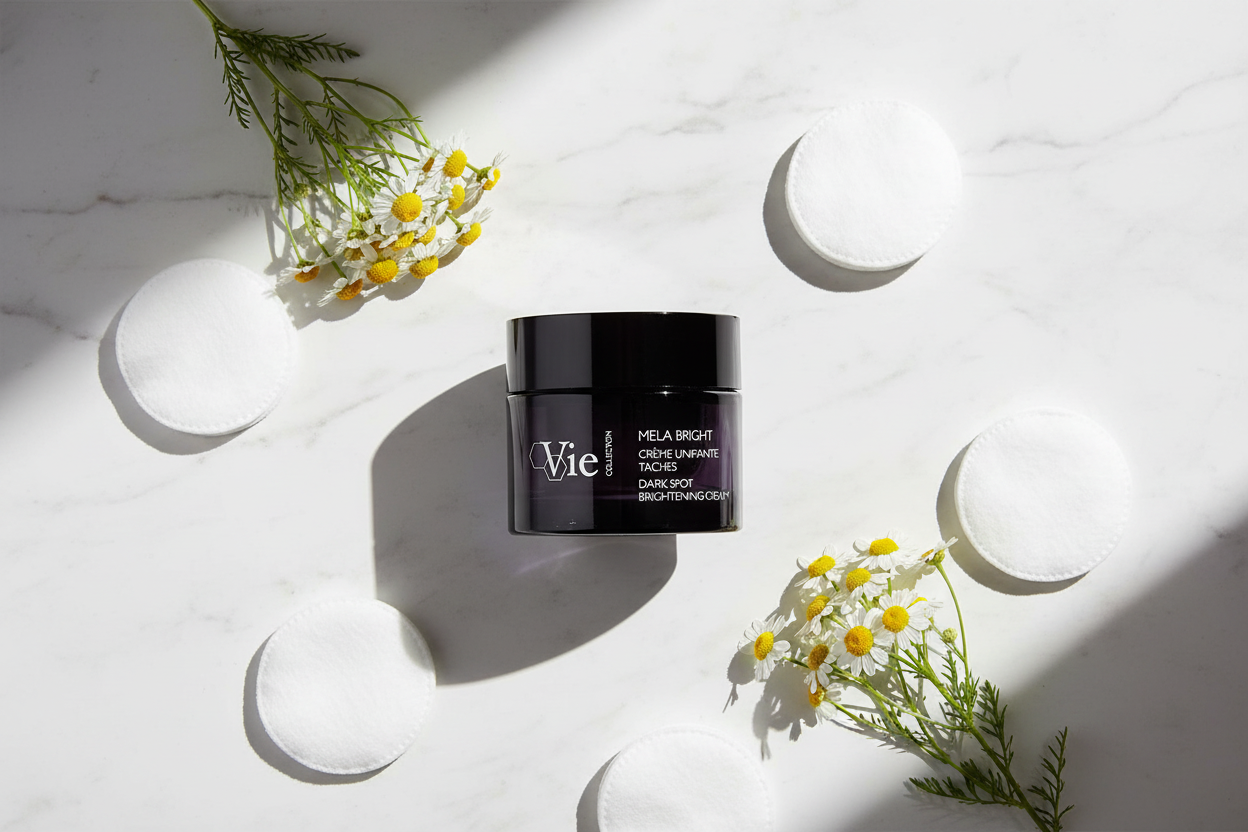 VIE COLLECTION Mela Bright Dark Spot Brightening Cream 50ml jar on a white surface with flowers and moon phases