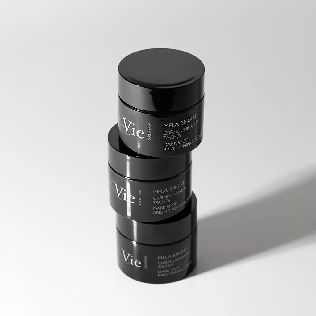 Three VIE COLLECTION Mela Bright Dark Spot Brightening Cream 50ml jars stacked on a light gray background